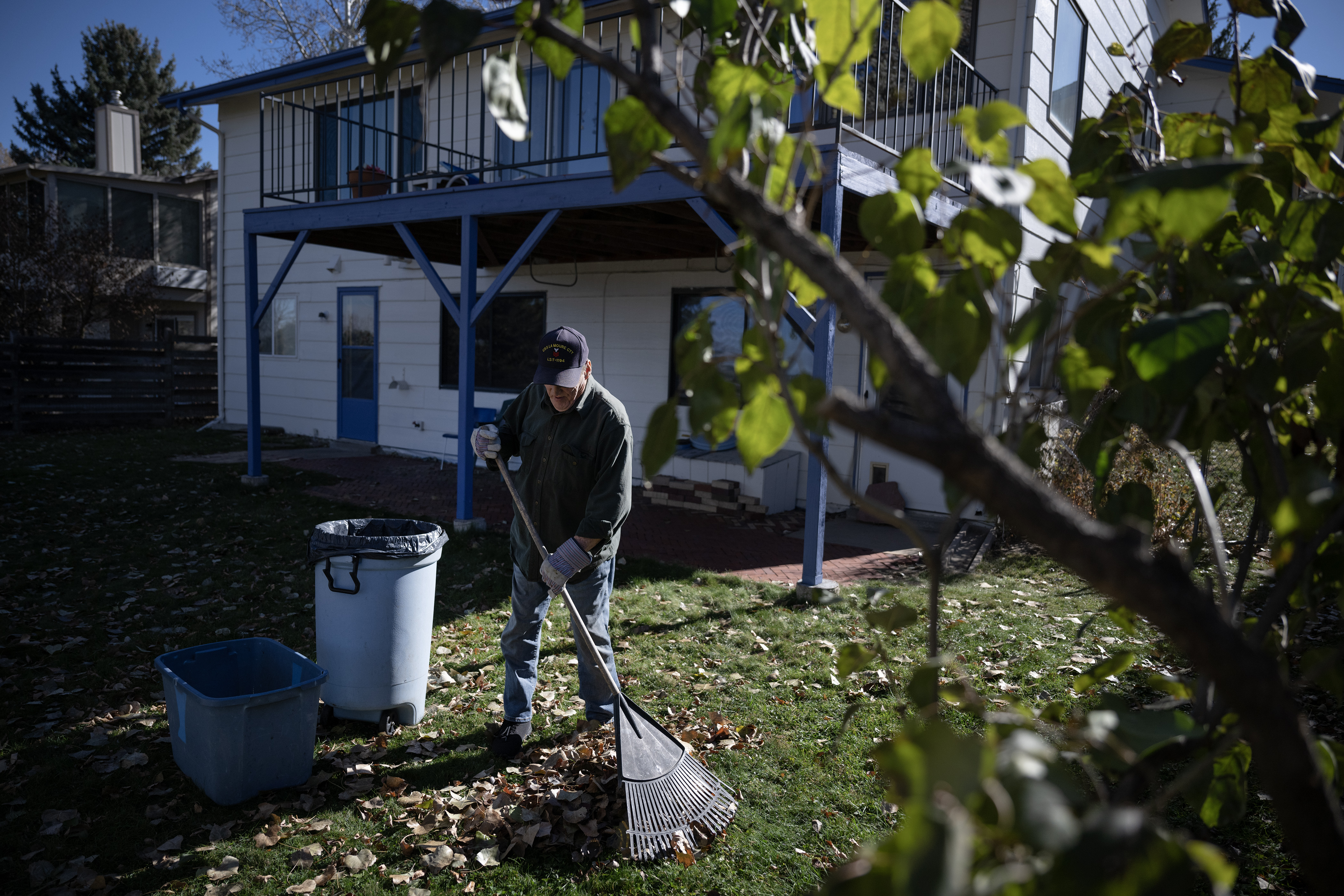 Martin J. Holmes III, 75, begins raking fallen leaves in Sally Collins’, 87, home on Friday, Nov. 10, 2023, in Arvada, Colo. (Timothy Hurst/Denver Gazette) (TimHursttim.hurst@gazette.comhttps://secure.gravatar.com/avatar/aca82bd62b4ee425c598527cd6faa1b1?d=mm&r=g)