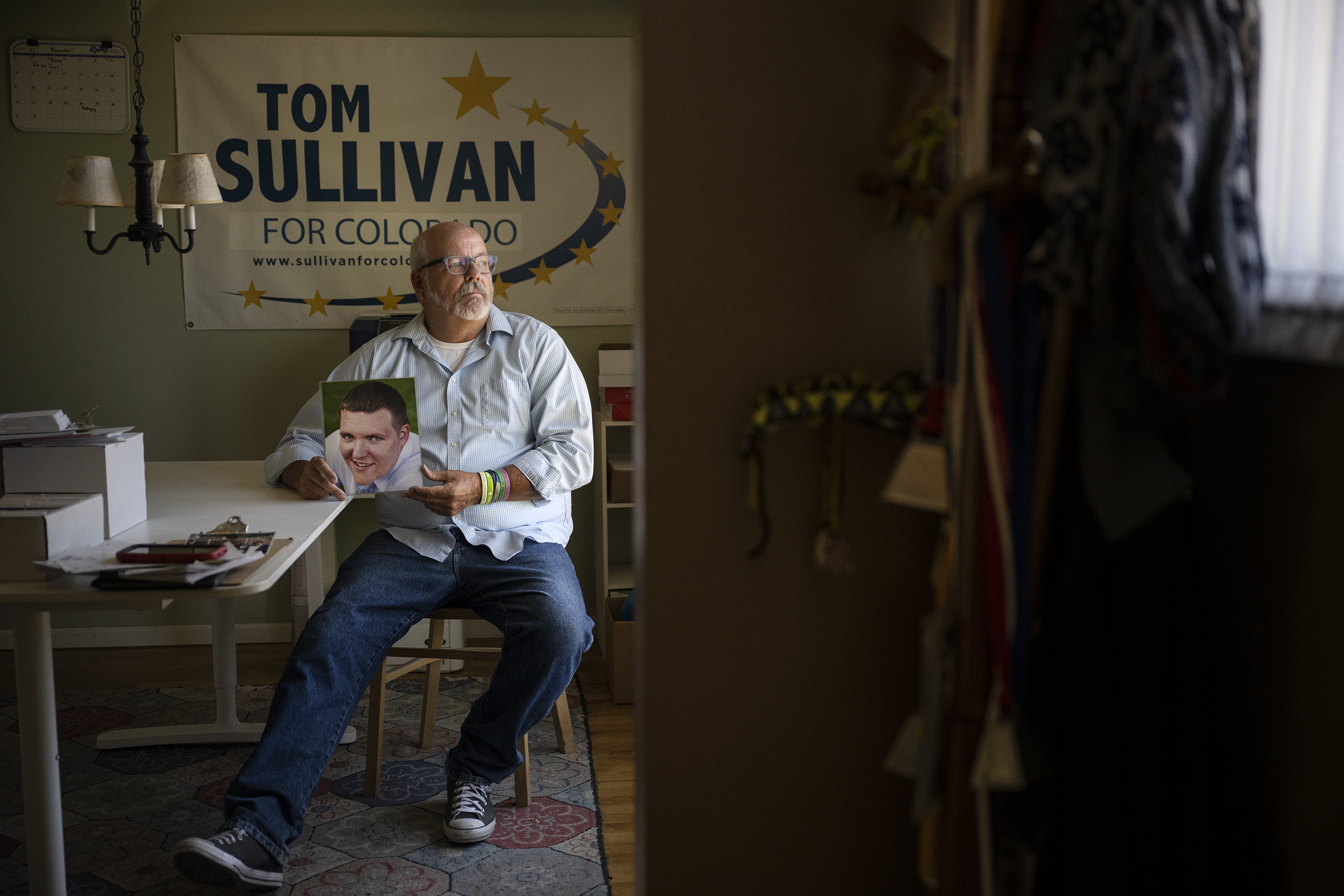 Rep. Tom Sullivan, whose son, Alex Sullivan, was one of the victims killed in the 2012 Aurora theater shooting, holds a photo of Alex in 2022. Sullivan is prominently featured in the Denver Film Festival documentary, 