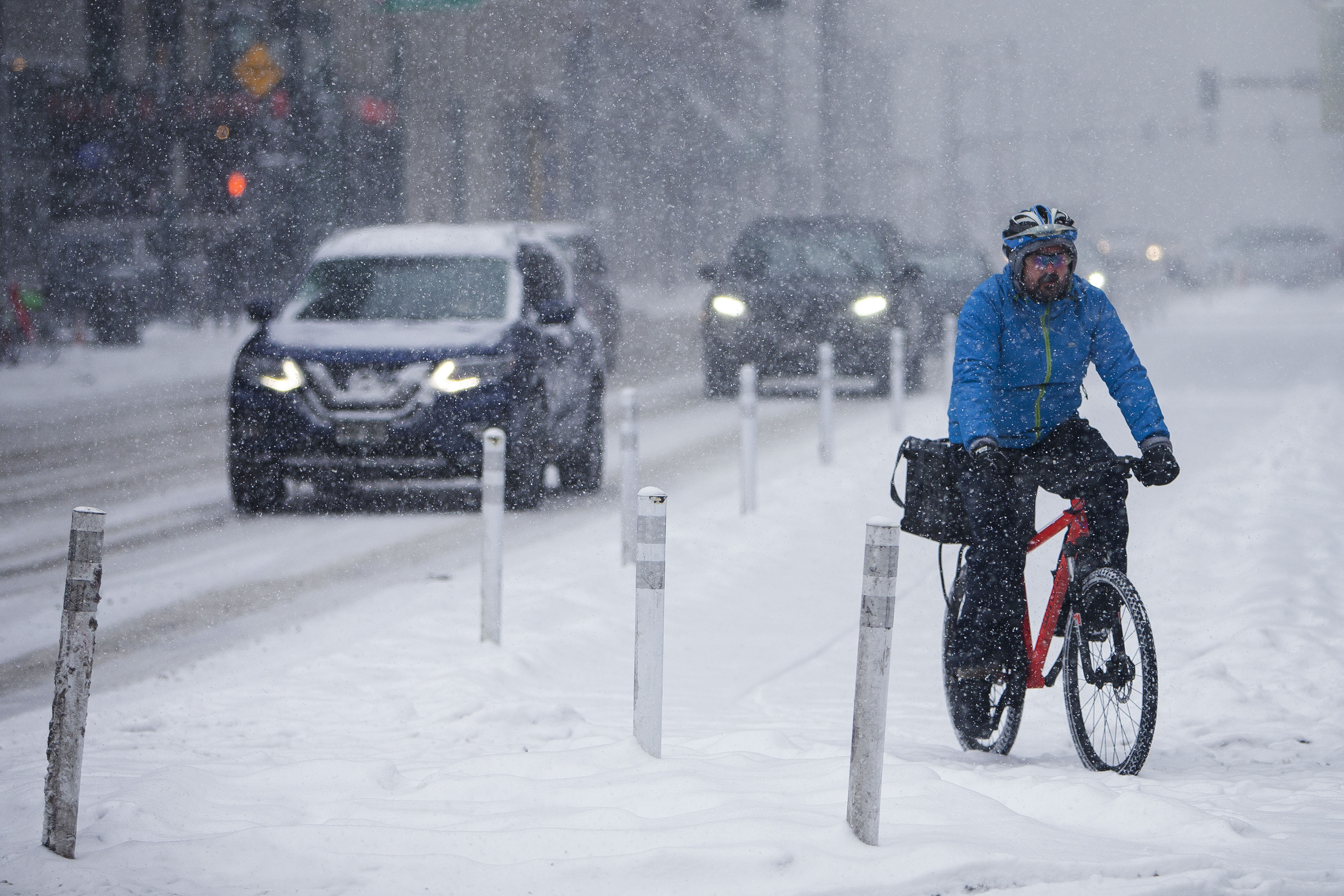 FILE PHOTO: A cyclist makes his way through traffic during a snowstorm on Thursday, Jan. 27, 2022, in Denver, Colo. (Timothy Hurst/The Gazette) (Timothy Hurst/Denver Gazette)