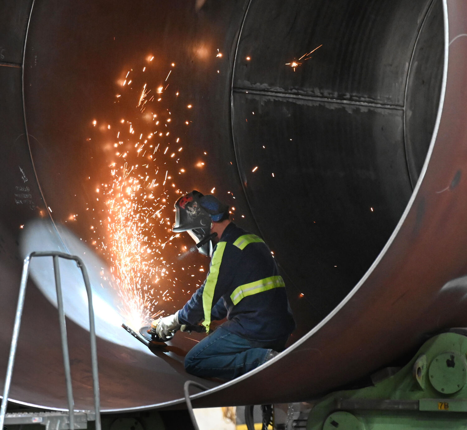 A welder works on a massive “can” or housing for a wind turbine while Pres. Joe Biden toured CS Wind in Pueblo on Wednesday, Nov. 29, 2023. (Photo by Jerilee Bennett, The Gazette)