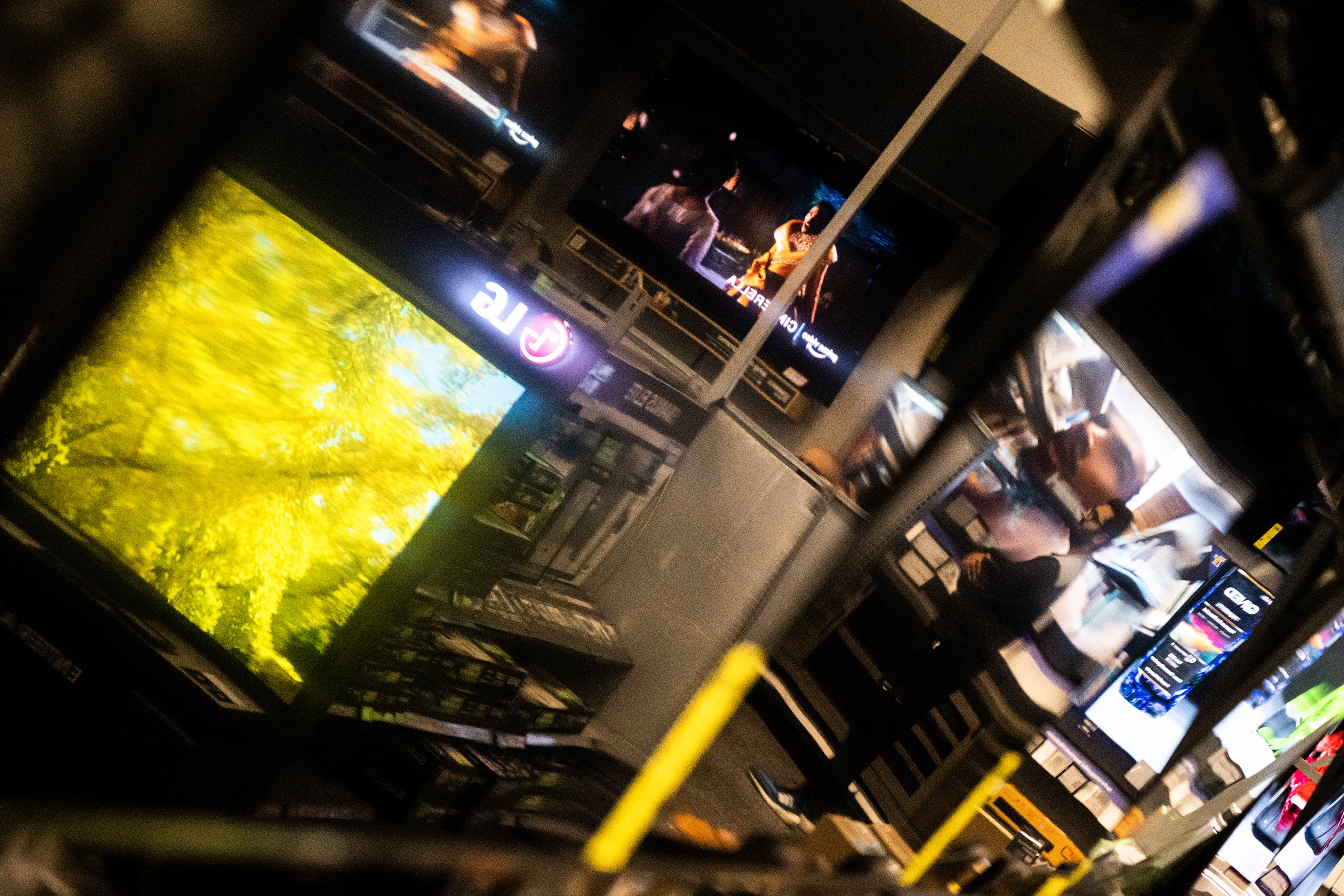 An employee is seen in the reflection of a wall of televisions for sale at Best Buy on Thursday, Nov. 24, 2023, in Lone Tree, Colo. (Timothy Hurst/Denver Gazette) (TimHursttim.hurst@gazette.comhttps://secure.gravatar.com/avatar/aca82bd62b4ee425c598527cd6faa1b1?d=mm&r=g)