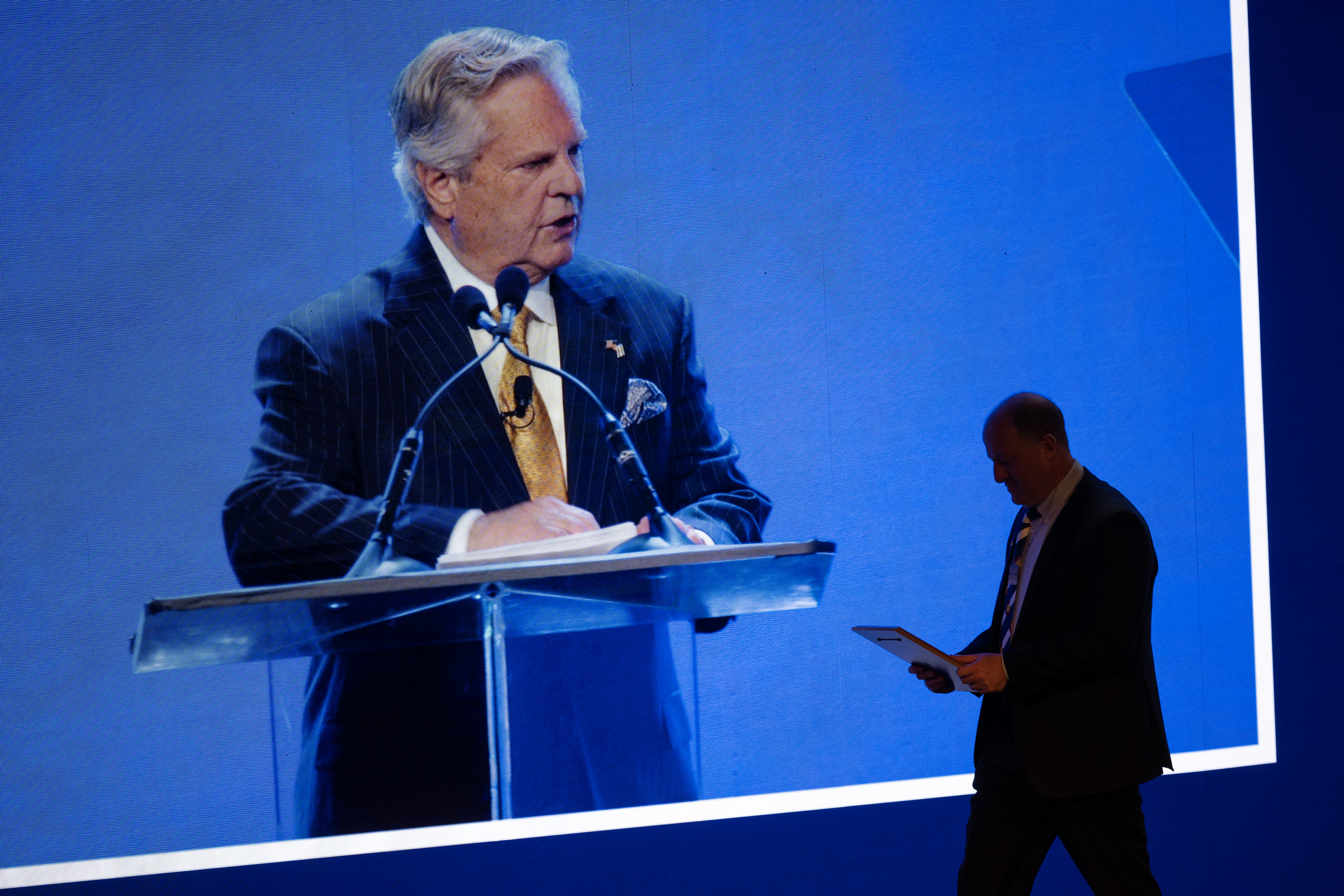 Jewish National Fund-USA president Dr. Sol Lizerbram is shown speaking on a screen as Gov. Jared Polis heads off-stage with a plaque presented to him by Lizerbram during the Jewish National Fund-USA’s Global Conference for Israel’s Opening Plenary on Thursday, November 30, 2023, at the Colorado Convention Center in Denver, Colo. (Timothy Hurst/Denver Gazette) (TimHursttim.hurst@gazette.comhttps://secure.gravatar.com/avatar/aca82bd62b4ee425c598527cd6faa1b1?d=mm&r=g)