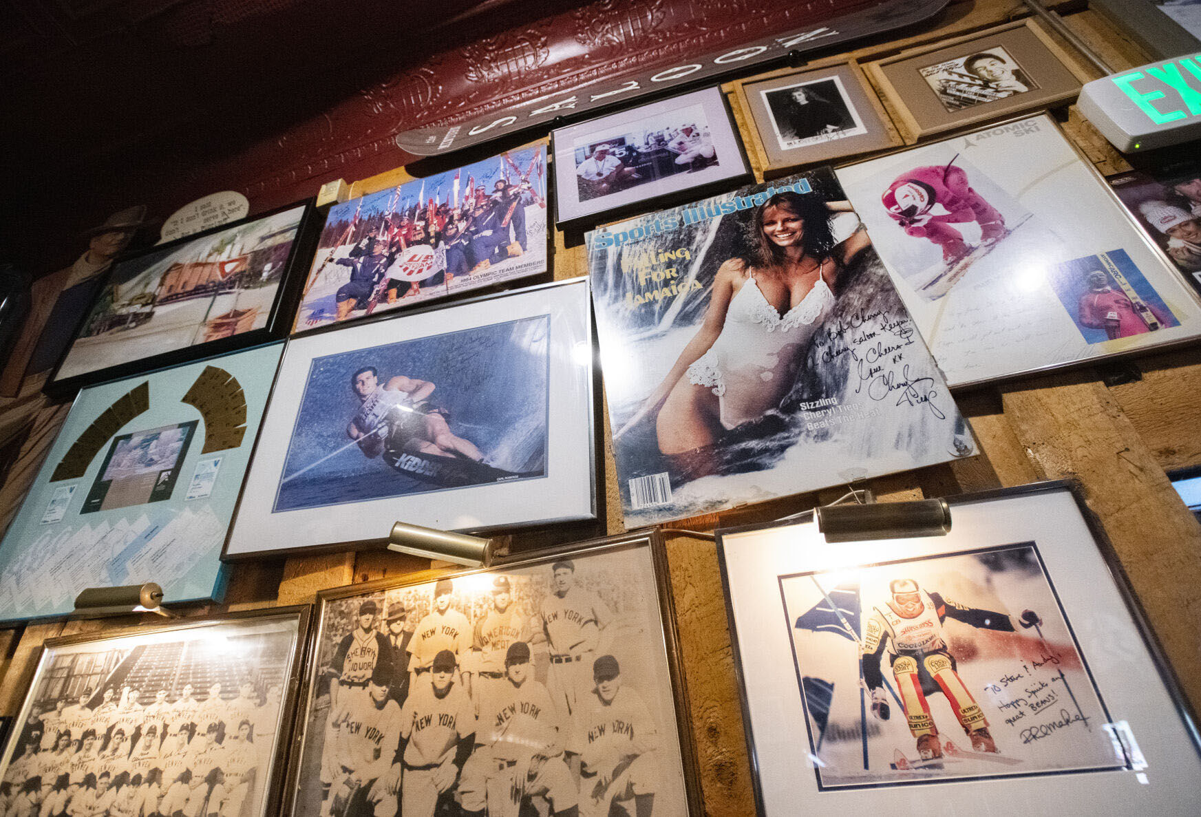 Autographed photos including the Sports Illustrated cover with model Cheryl Tiegs cover the walls of the historic Minturn Saloon Tuesday, Oct. 5, 2021, in Minturn, Colo. (The Gazette, Christian Murdock)