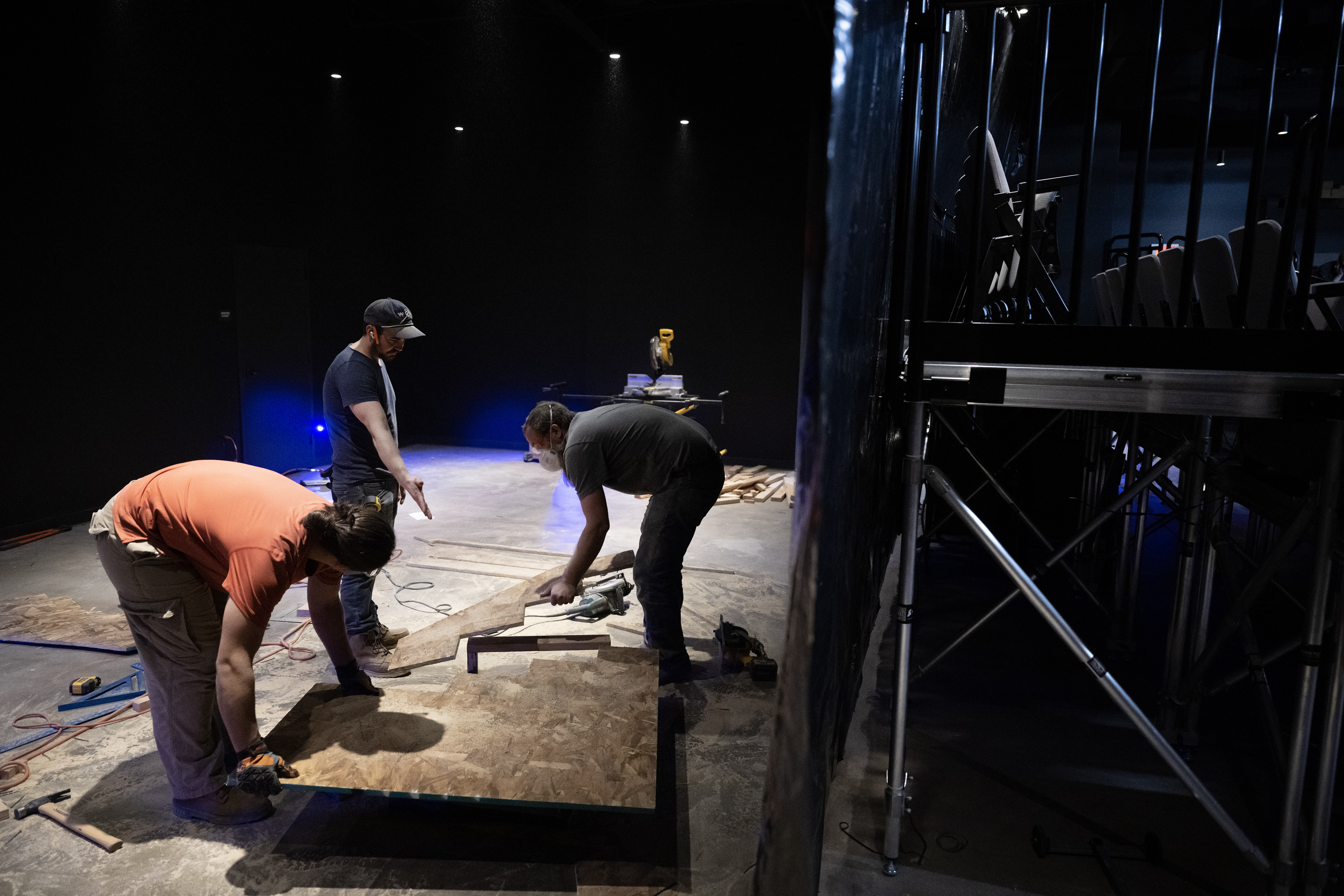 From left, Tanis Gonzales, John Hauser and Jonathan Scott-McKean build stairs for the set of