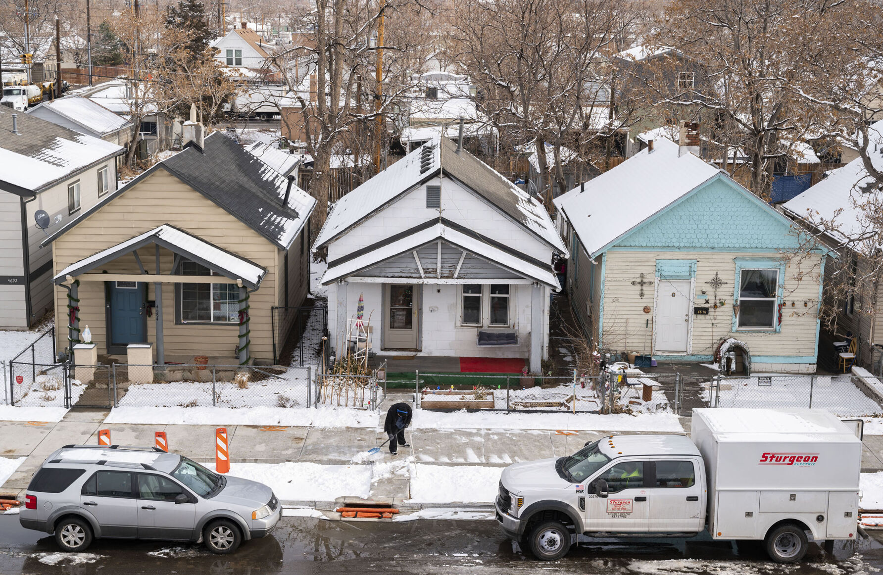 A resident shovels snow after a storm on York Street, a block north of the Interstate 70 viaduct in the Globeville neighborhood in Denver. (The denver Gazette file)