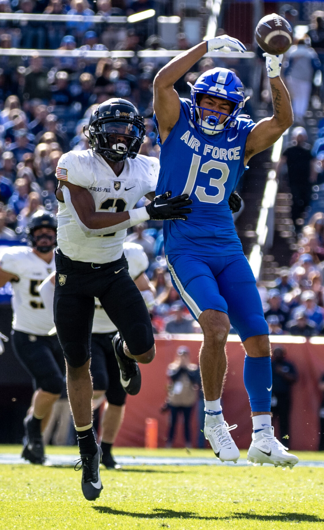 Army Black Knights defensive back Bo Nicolas-Paul (2) interferes with a pass as Air Force Falcons wide receiver Jared Roznos (13) jumps to make the catch in the first half of an NCAA college football game on Saturday, Nov. 4, 2023, at Empower Field at Mile High in Denver, Colo. (Parker Seibold, The Gazette) (Parker Seibold)