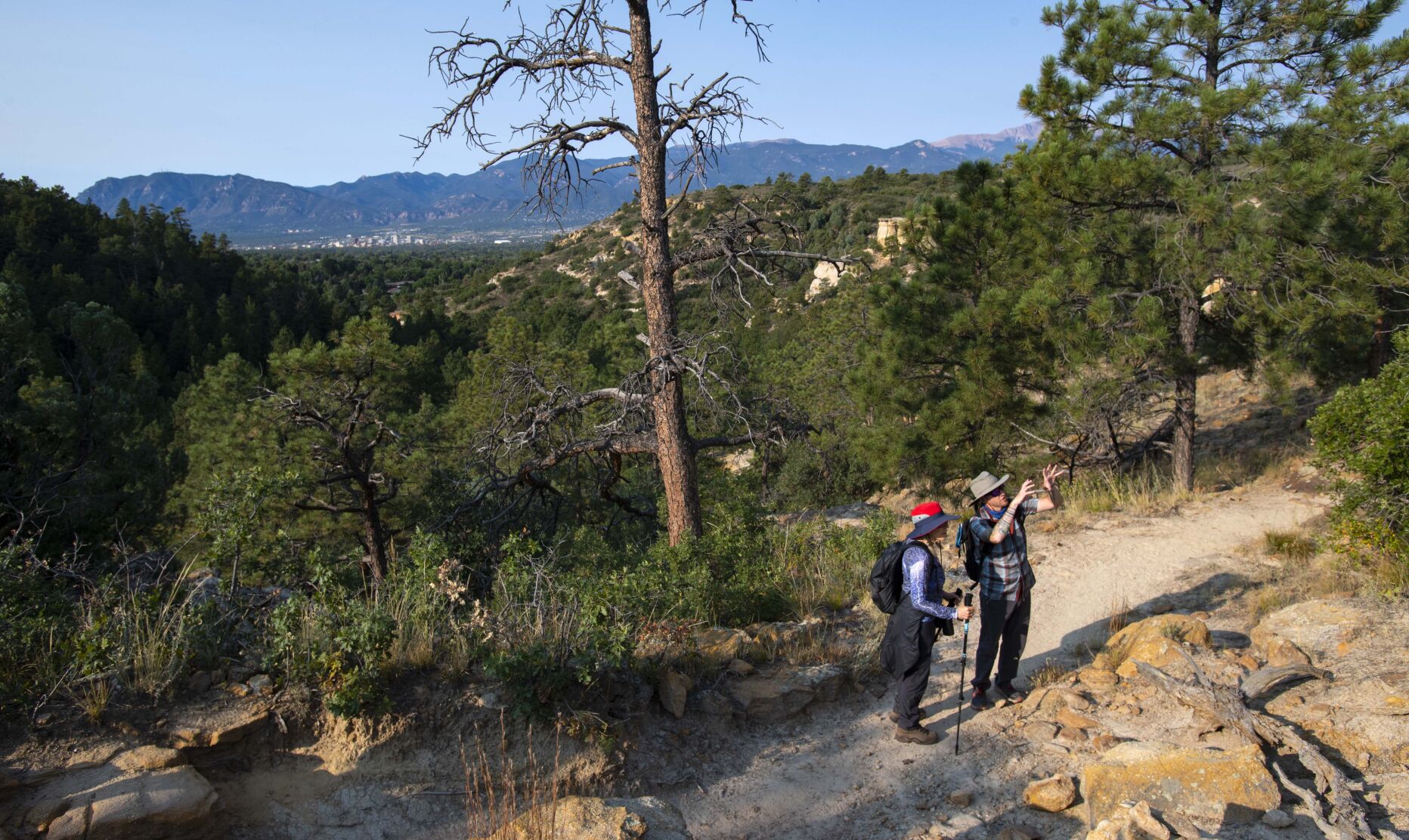 Hike for Life guide Jason McEwen describes what hoodoos are to his client Heidi Fessler while they hike through Palmer Park on Sept. 23, 2021. (Christian Murdock, The Gazette)