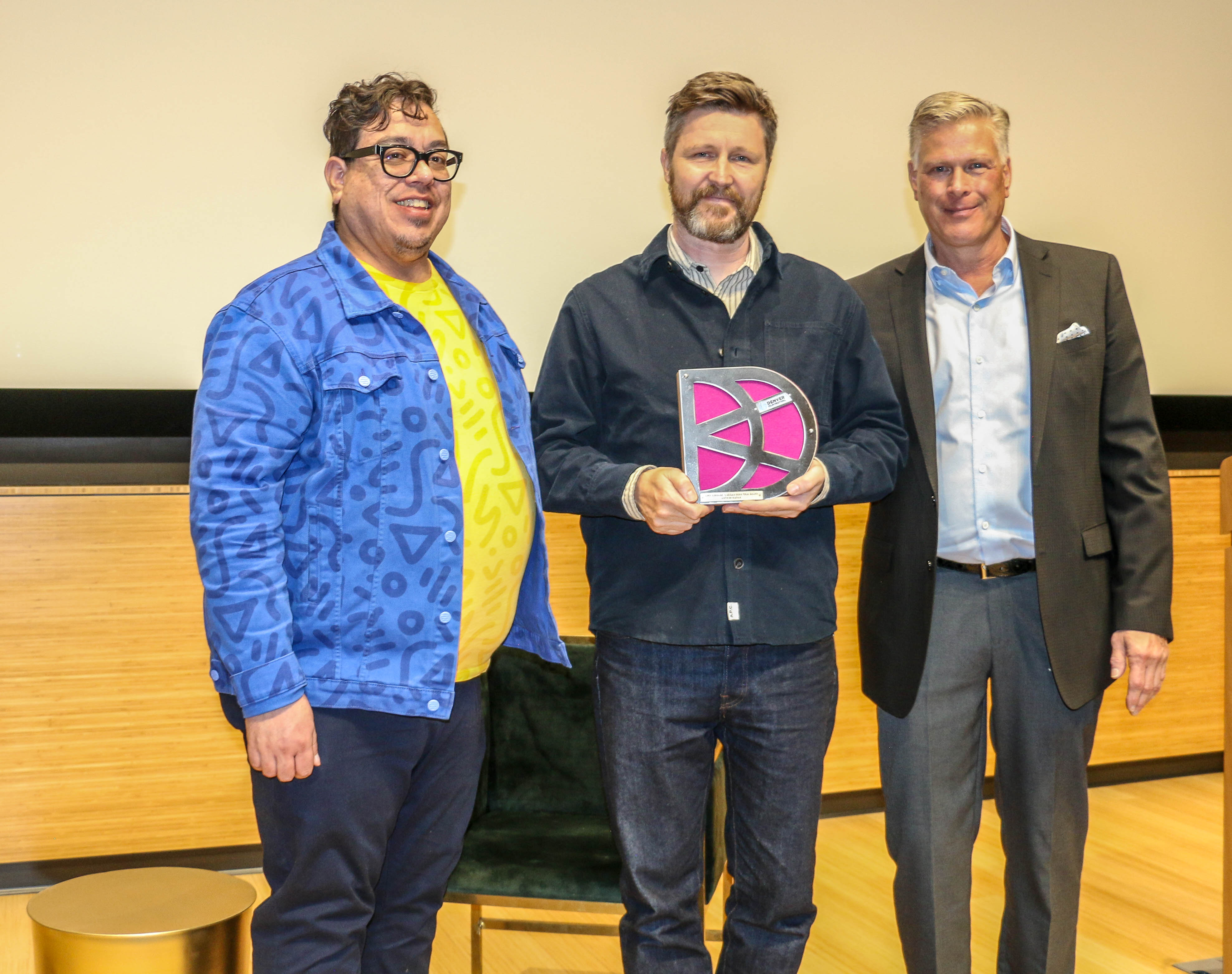 Andrew Haigh receives the Denver Film Festival's CinemaQ LaBahn Ikon Film Award – presented to an outstanding entertainment contributor from the LGBTQIA+ community – from Denver Film's Keith Garcia, left, and benefactor William LaBahn at the Denver Botanic Gardens. (JOHN MOORE)