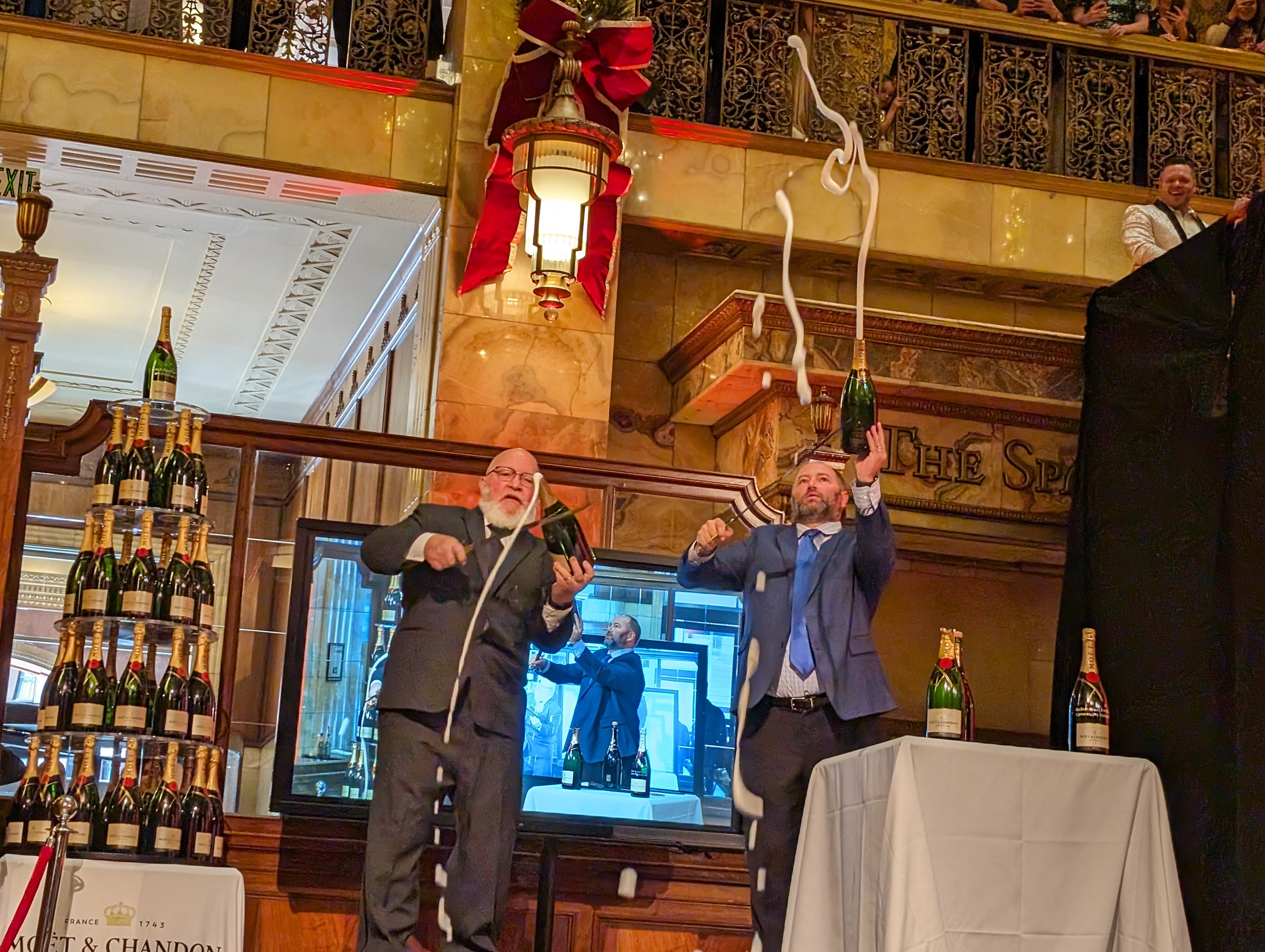 Father and son duo, Dennis and Matthew Dinsmore, cut open the countless champagne bottles poured onto the tower with Napoleonic sabers.The father, Dennis, has been working at the event for over 30 years. Matthew has been helping for 15. His daughter, now 16, will help takeover the bottle-cutting duties in a few years, Matthew said. (SageKelleyJefferson County Reportersage.kelley@denvergazette.comhttps://denvergazette.com/content/tncms/avatars/e/5f/457/e5f45740-2717-11ee-85b2-ab80f2d36252.5b966c1d2ce4987987665d57c237eda4.png)