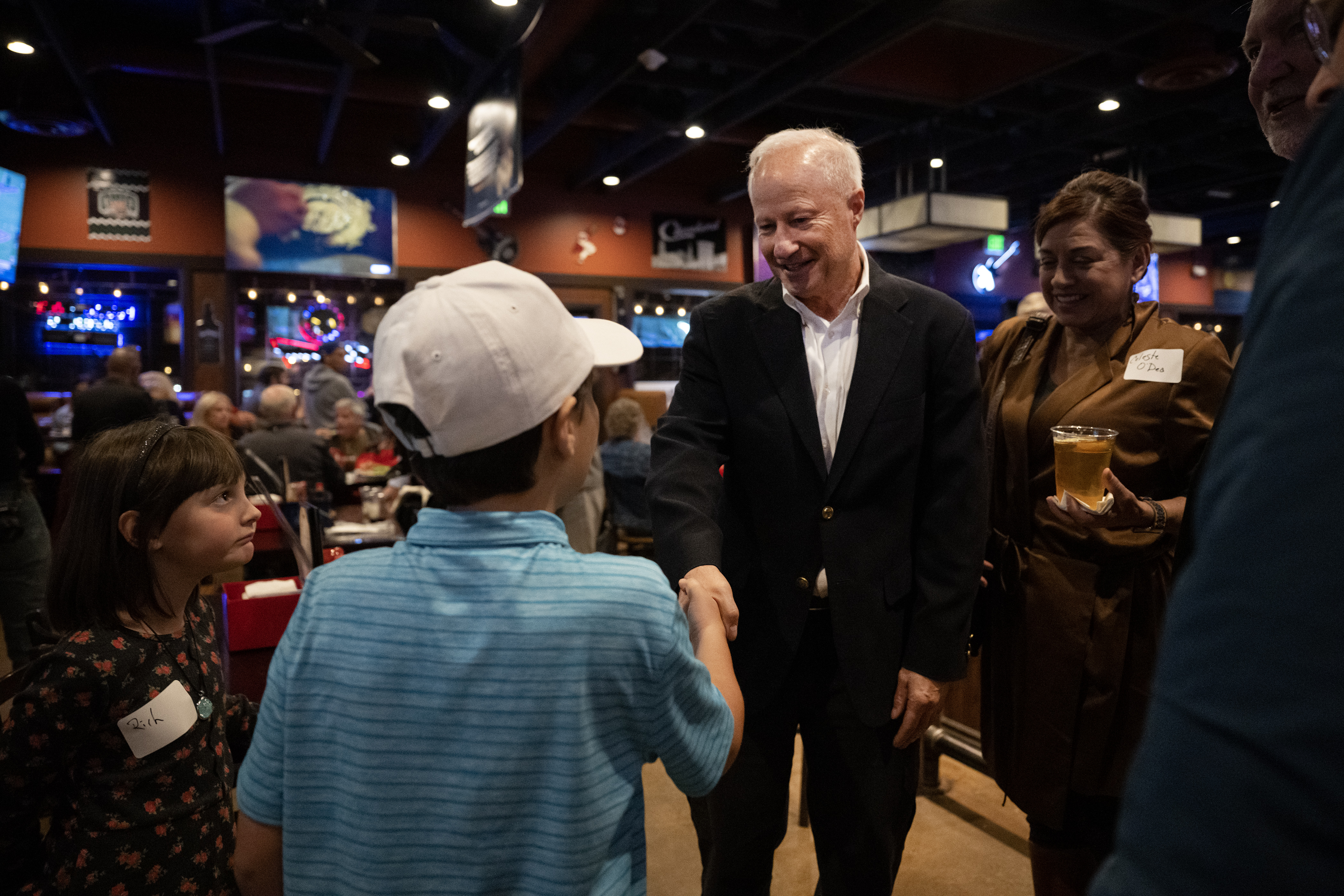 Incumbent Aurora Mayor Mike Coffman greets brother and sister Grayson and Izzy Coolidge, 10 and 6, after early election results show him leading during the “No On HH - Advance Colorado election night watch party” on Tuesday, Nov. 7, 2023, at JJ's Place in Aurora, Colo. (Timothy Hurst/Denver Gazette) (TimHursttim.hurst@gazette.comhttps://secure.gravatar.com/avatar/aca82bd62b4ee425c598527cd6faa1b1?d=mm&r=g)