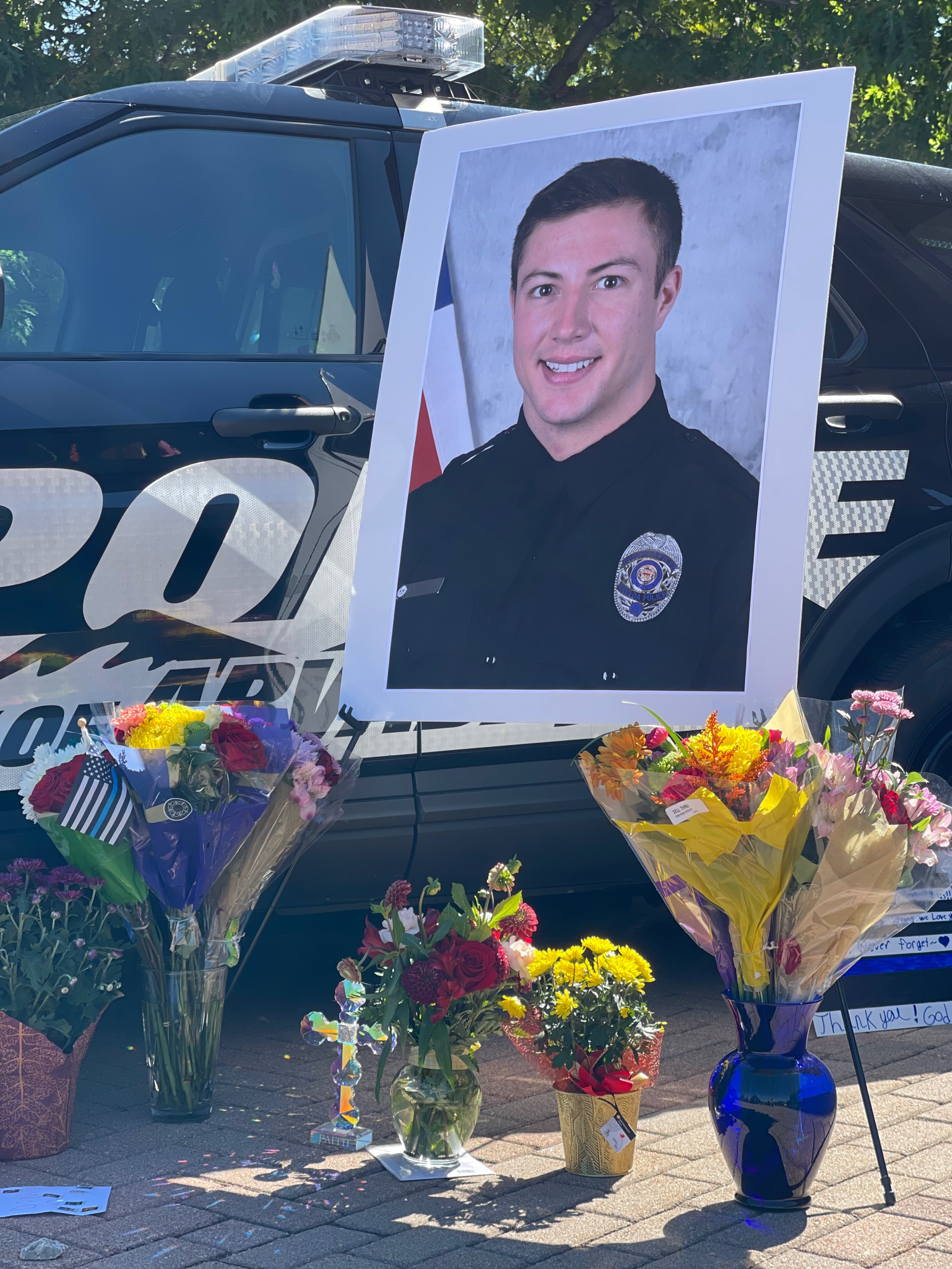A makeshift shrine has been erected in front of the Arvada Police Department in memory of officer Dillon Michael Vakoff, who was killed in the line of duty, in 2022. (The Denver Gazette file)