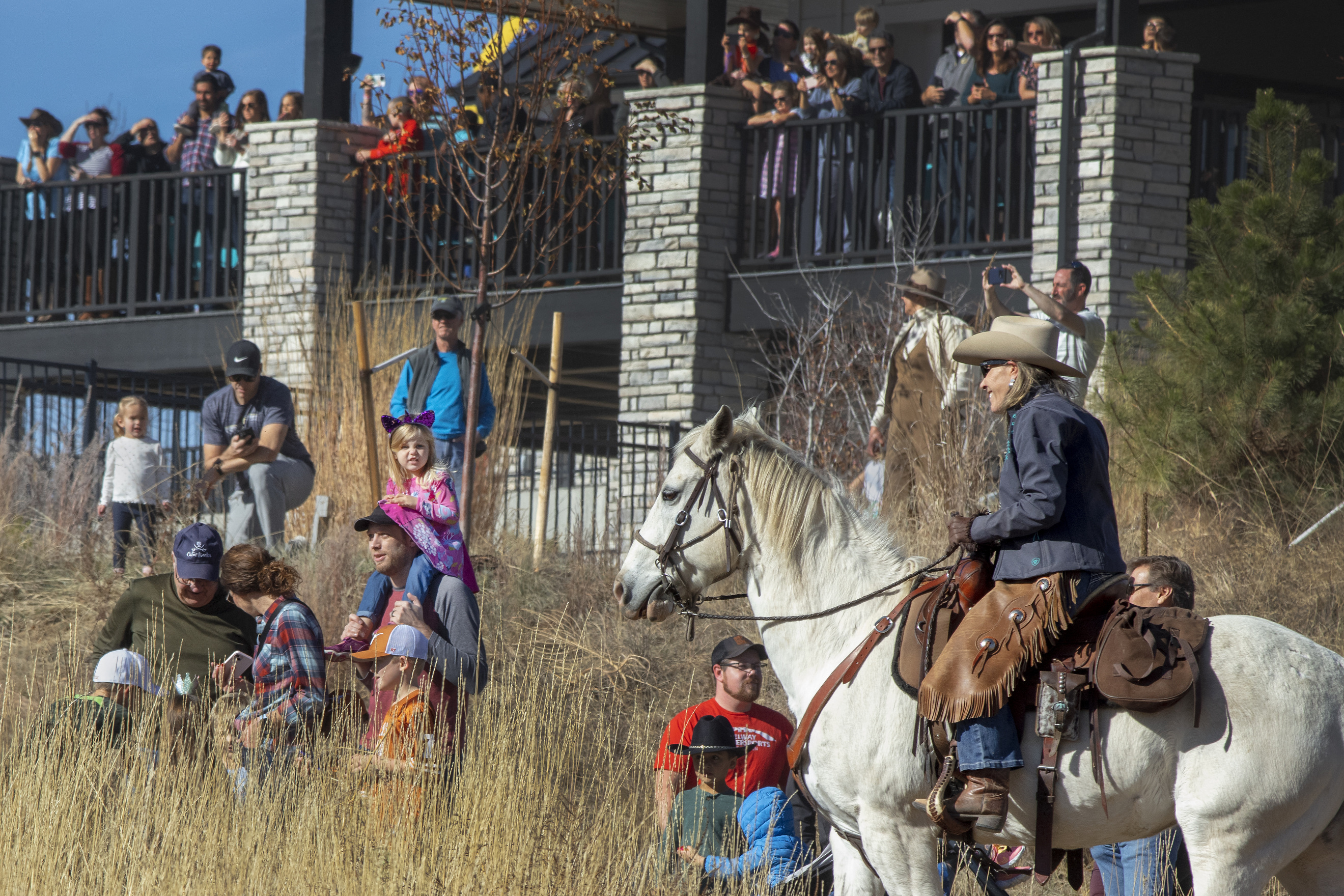 Residents watch cowboys and cowgirls herding cattle across the 3,400-acre Sterling Ranch property on Saturday, Nov. 4, 2023. The cattle are brought from their summer grazing pastures to their winter home as part of a rotational grazing strategy, which is critical way to foster a healthier ecosystem across landscapes. (Bear Gutierrez/Special to The Denver Gazette) (Bear Gutierrez/Special to The Denver Gazette)