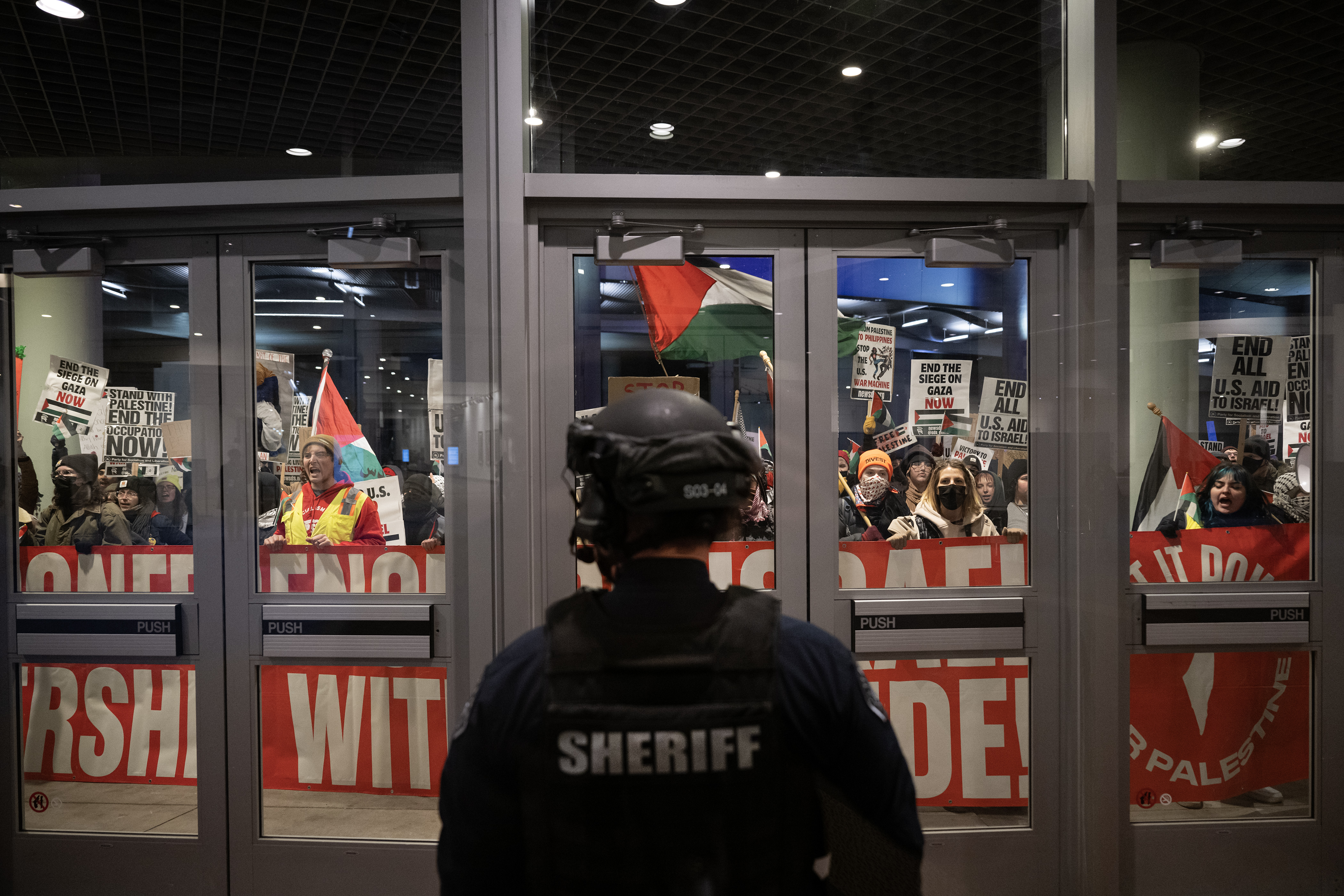 Polis urges Coloradans to stand behind Israel as pro-Palestinian protesters bang on windows