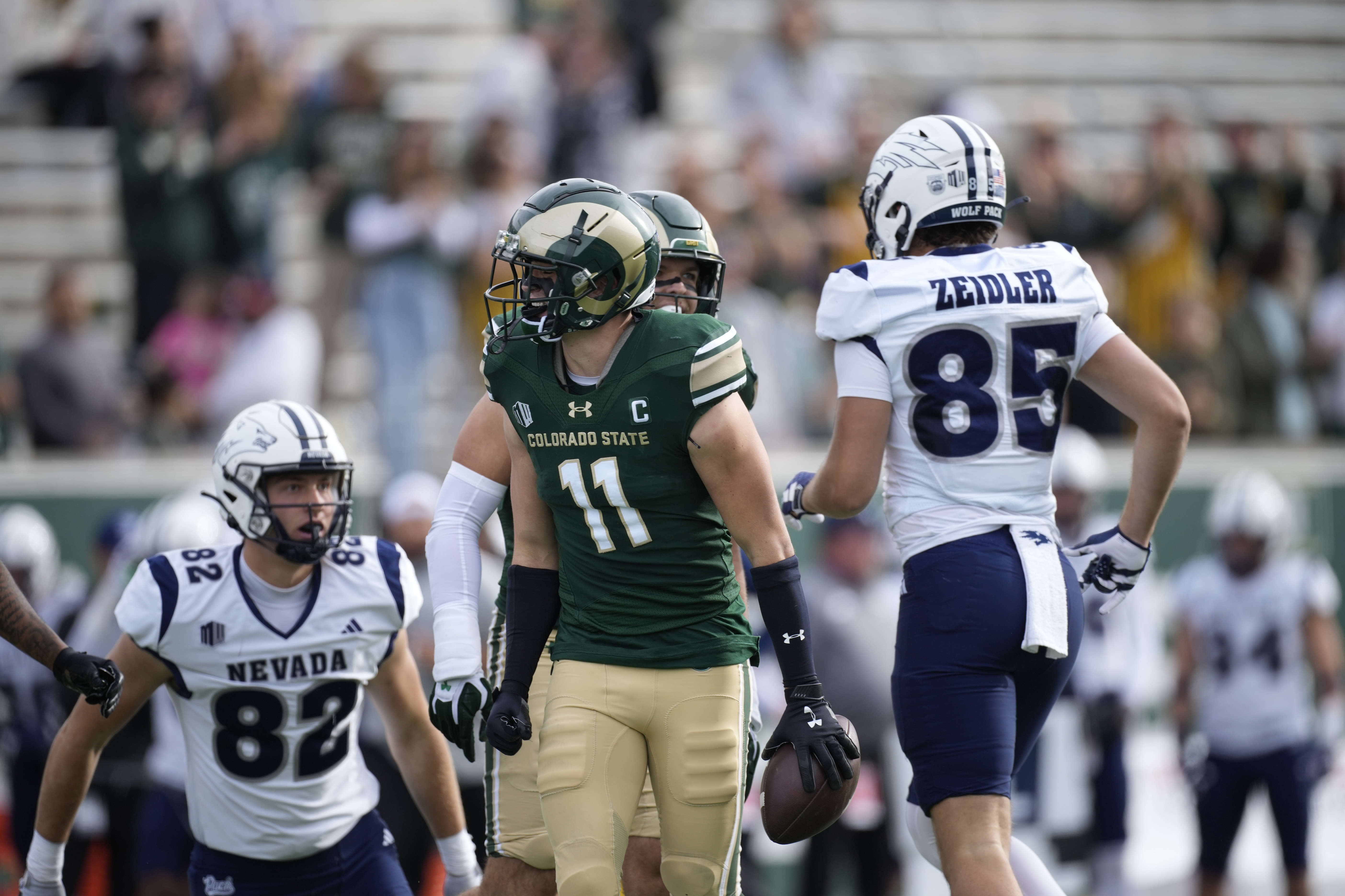 Colorado State defensive back Henry Blackburn (11) celebrates after intercepting a pass intended for Nevada tight end Cameron Zeidler (85) in the first half of an NCAA college football game Saturday, Nov. 18, 2023, in Fort Collins, Colo. (AP Photo/David Zalubowski) (David Zalubowski)