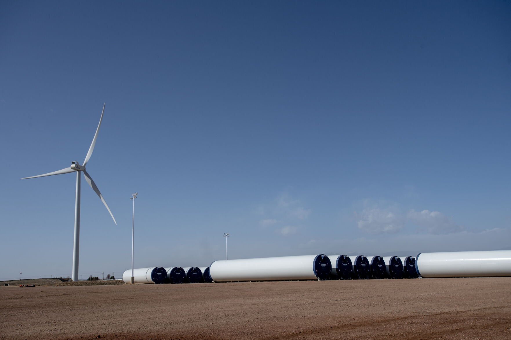 A wind turbine and newly manufactured towers on the CS Wind property on April 14, 2023 in Pueblo, Colo. Earlier this year, the South Korean-based wind tower manufacturing company announced its plans to expand the world’s largest wind tower manufacturing plant in Pueblo. (Parker Seibold, The Gazette) (Parker Seibold)