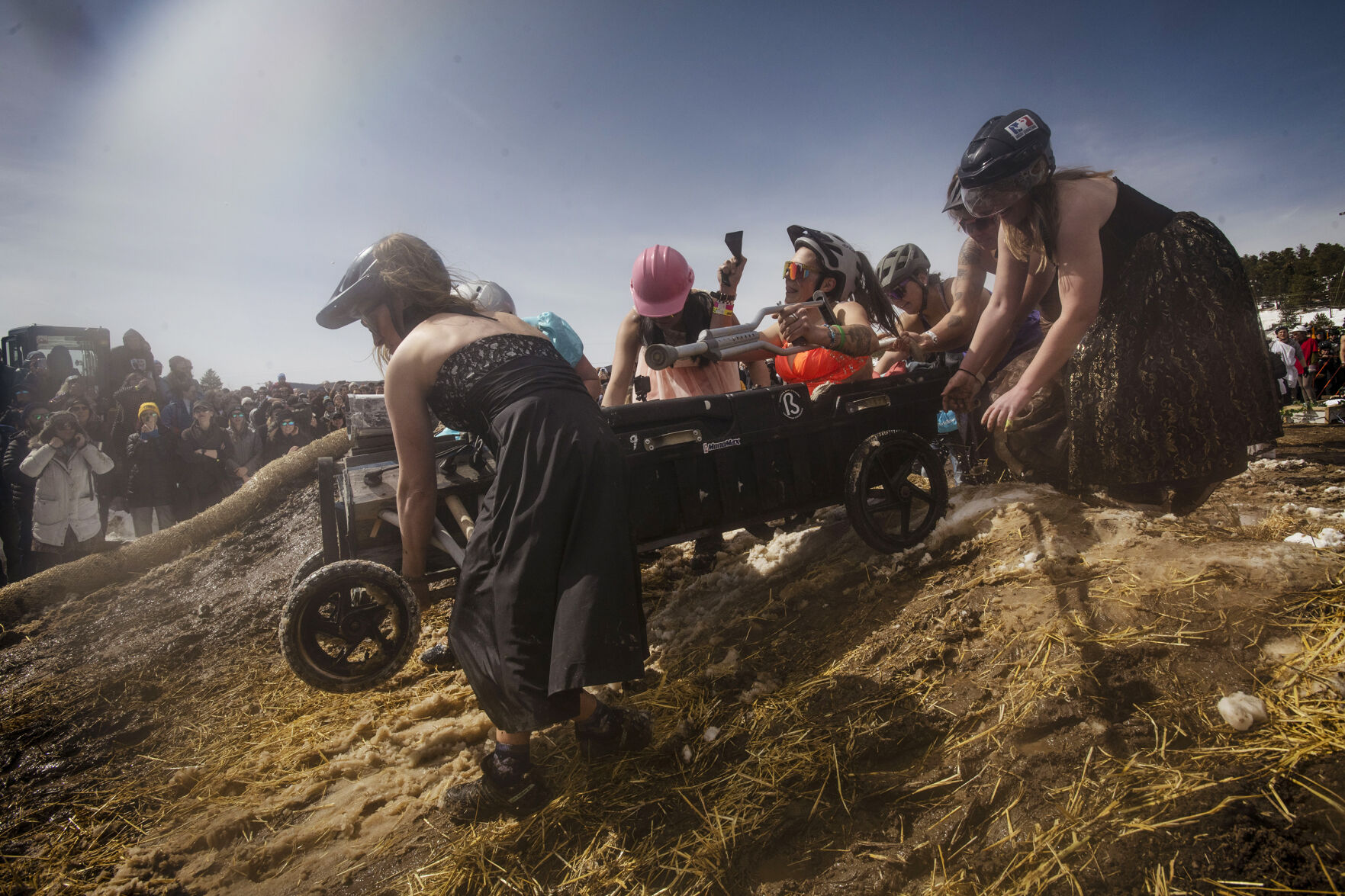 Participants brave the mud and slush as they compete in the coffin races during the Frozen Dead Guy Days in Nederland, Colo., on Saturday, March 19, 2022. The festival returned after being cancelled the past two years due to the COVD-19 pandemic. Thousands attended the event to witness the iconic coffin races, polar plunge, frozen turkey bowling and much more that continues through Sunday. (Chancey Bush /The Gazette) (Chancey Bush/ The Gazette)