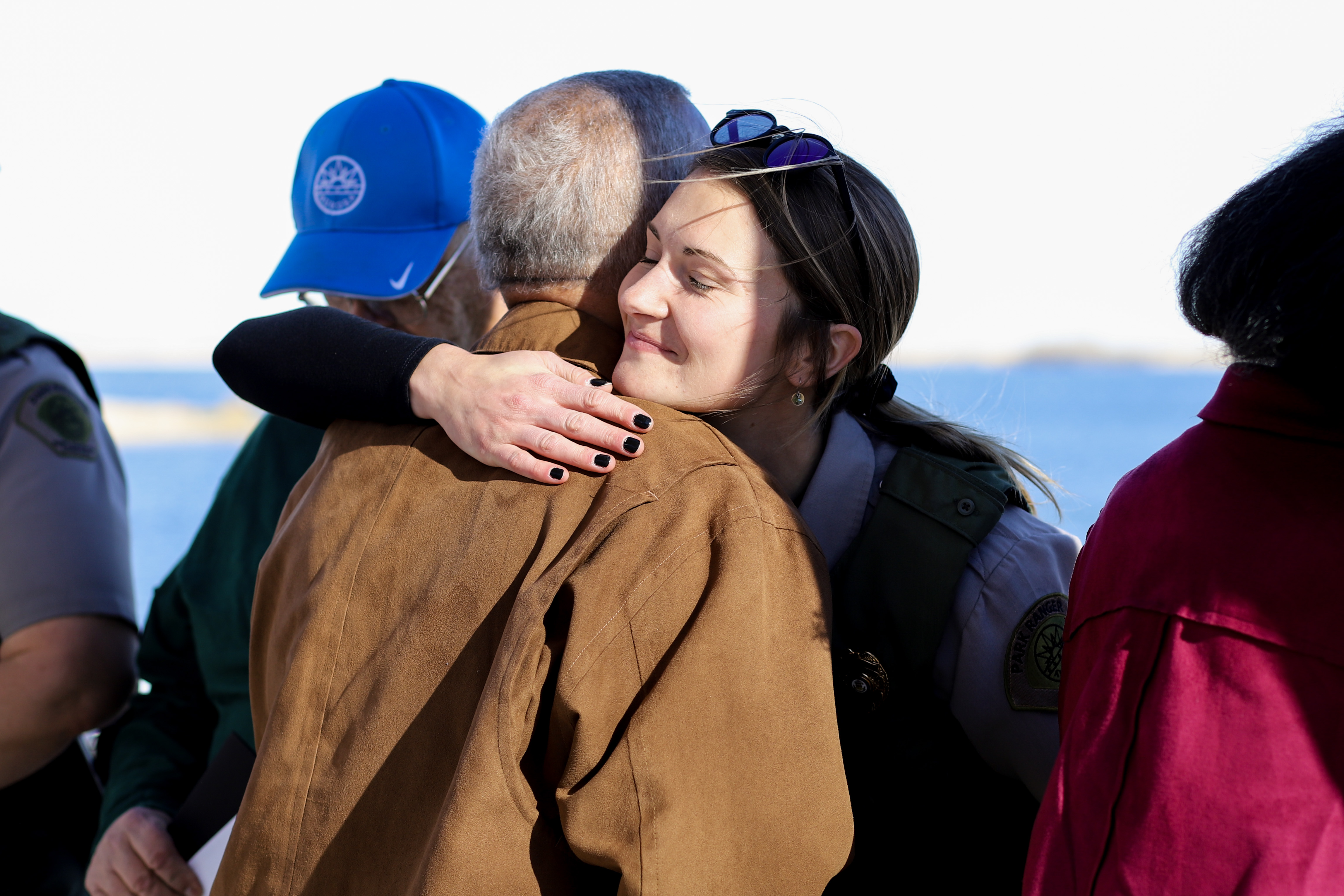 Dwayne Williams, 68, who went into unexpected cardiac arrest at Aurora Reservoir in late September, hugs Aurora Park Ranger Cassidy Brown, one of the rangers who responded with an AED and CPR and helped save Williams' life. (Kyla Pearce)