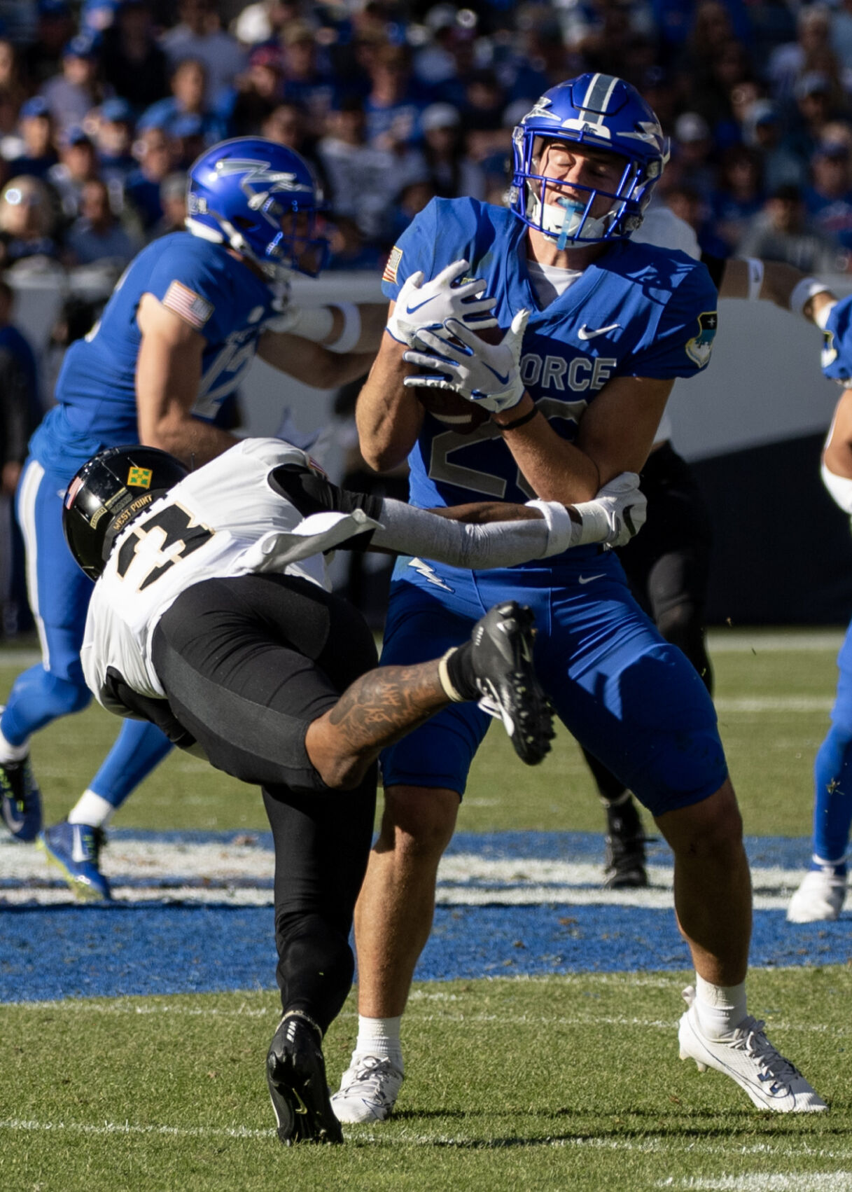 Air Force Falcons wide receiver Dane Kinamon (23) is tackled by Army Black Knights wide receiver Ay'Jaun Marshall in the second half of an NCAA college football game on Saturday, Nov. 4, 2023, at Empower Field at Mile High in Denver, Colo. (Parker Seibold, The Gazette) (Parker Seibold)
