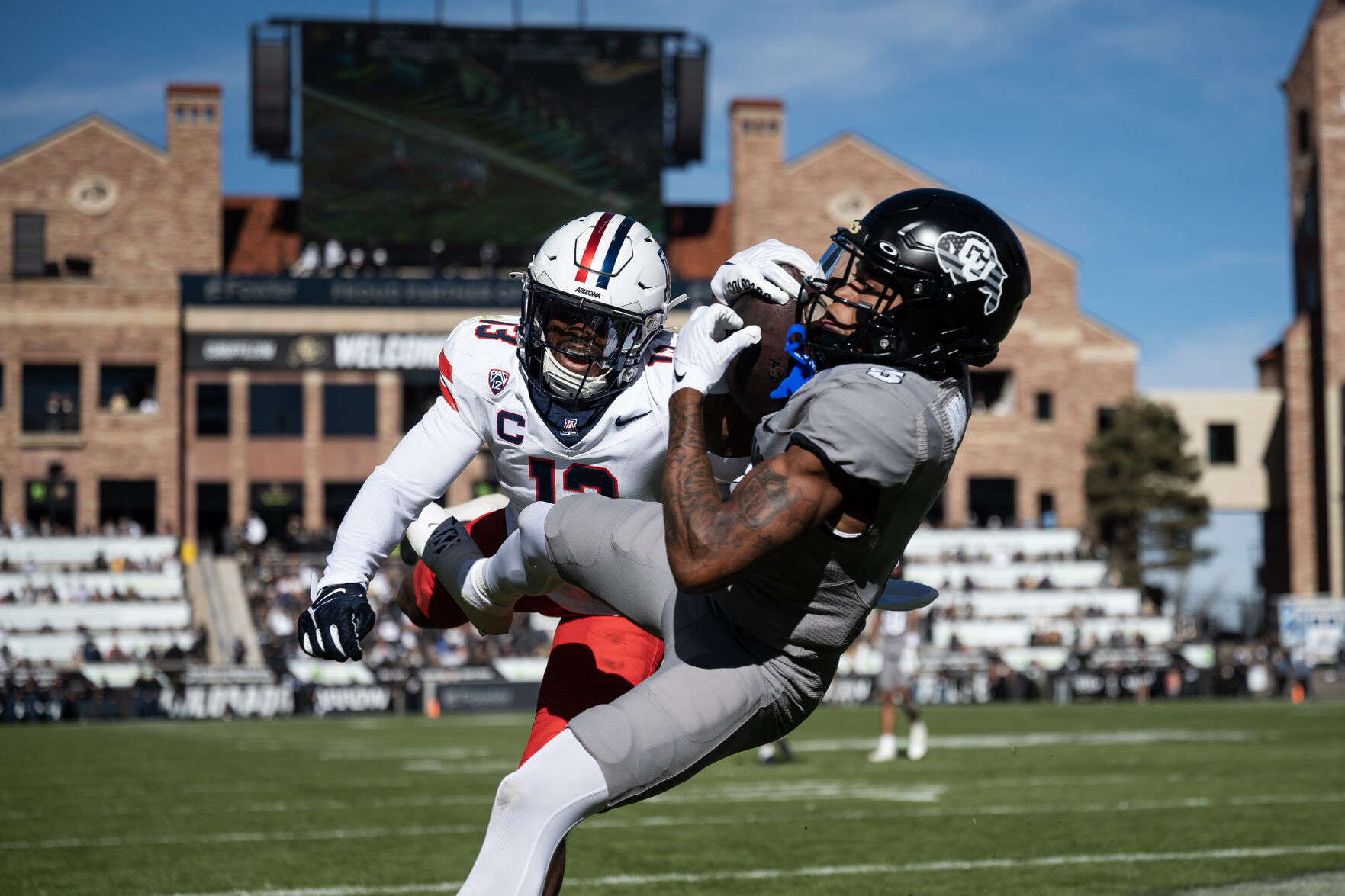 Colorado Buffaloes wide receiver Jimmy Horn Jr. (5) falls into the end zone past Arizona Wildcats defensive back Martell Irby (13) on a reception from Colorado Buffaloes quarterback Shedeur Sanders (2) on Saturday, Nov. 11, 2023, at Folsom Field in Boulder, Colo. (Timothy Hurst/Denver Gazette) (TimHursttim.hurst@gazette.comhttps://secure.gravatar.com/avatar/aca82bd62b4ee425c598527cd6faa1b1?d=mm&r=g)
