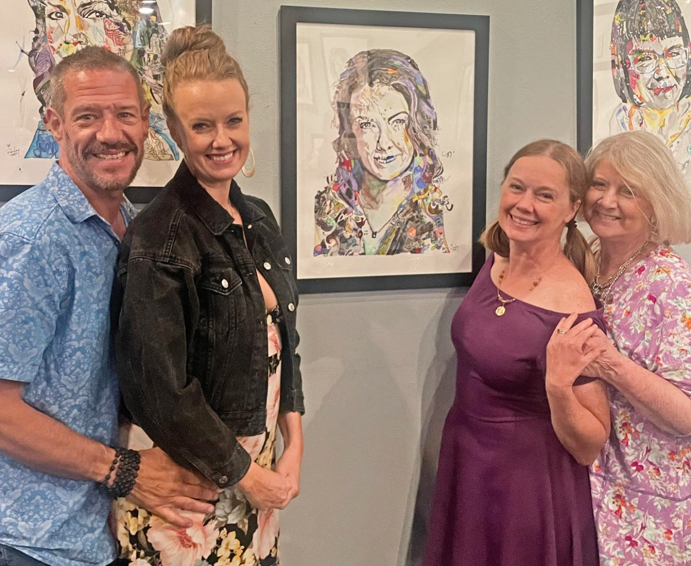 Local theater director Piper Arpan, second from left, poses along with her family next to the portrait made of her by Rick Long. Arpan is the director of Miners Alley Playhouse's current offering, 