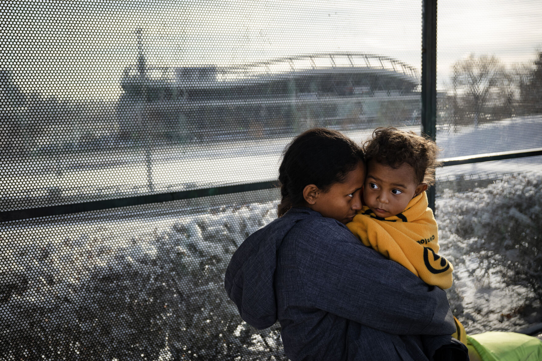 Newly arrived immigrant Ma'riussy Rosa'do nuzzles her one-year-old son Jeansdes after they, her partner and another family of immigrants were dropped off by a bus from El Paso, Texas, at the bus stop near Federal Boulevard and West 19th Avenue after an overnight snowstorm on Saturday, Dec. 9, 2023, in Denver, Colo. A local contact provided them with jackets, though they were dropped off wearing nothing more than socks and sandals on their feet. (Timothy Hurst/Denver Gazette) (TimHursttim.hurst@gazette.comhttps://secure.gravatar.com/avatar/aca82bd62b4ee425c598527cd6faa1b1?d=mm&r=g)
