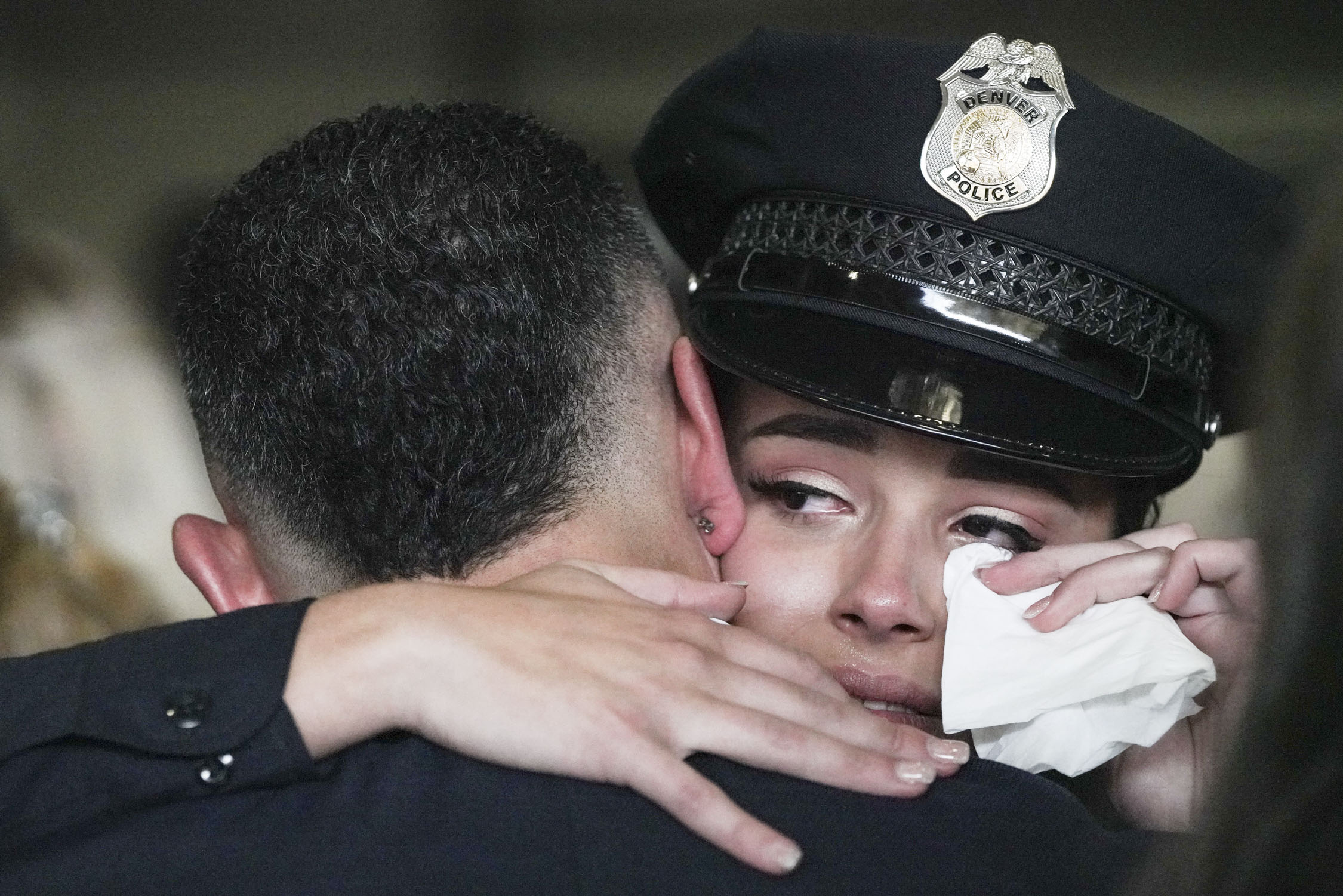 Breauna Espinal hugs her dad Omar while wiping tears from her face after the ceremony at the Denver Police Training Academy on Friday, Dec. 1, 2023 in Denver, Colo. 47 recruit officers were sworn in as Denver Police officers during the ceremony. (Rebecca Slezak/ Special to The Denver Gazette) (Rebecca Slezak)