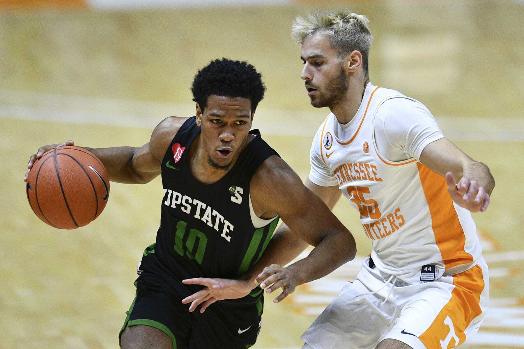 South Carolina-Upstate's Tommy Bruner (10) is guarded by Tennessee's Santiago Vescovi (25) during an NCAA college basketball game Wednesday, Dec. 23, 2020, in Knoxville, Tenn. (Saul Young/Knoxville News Sentinel via AP, Pool) (Saul Young)