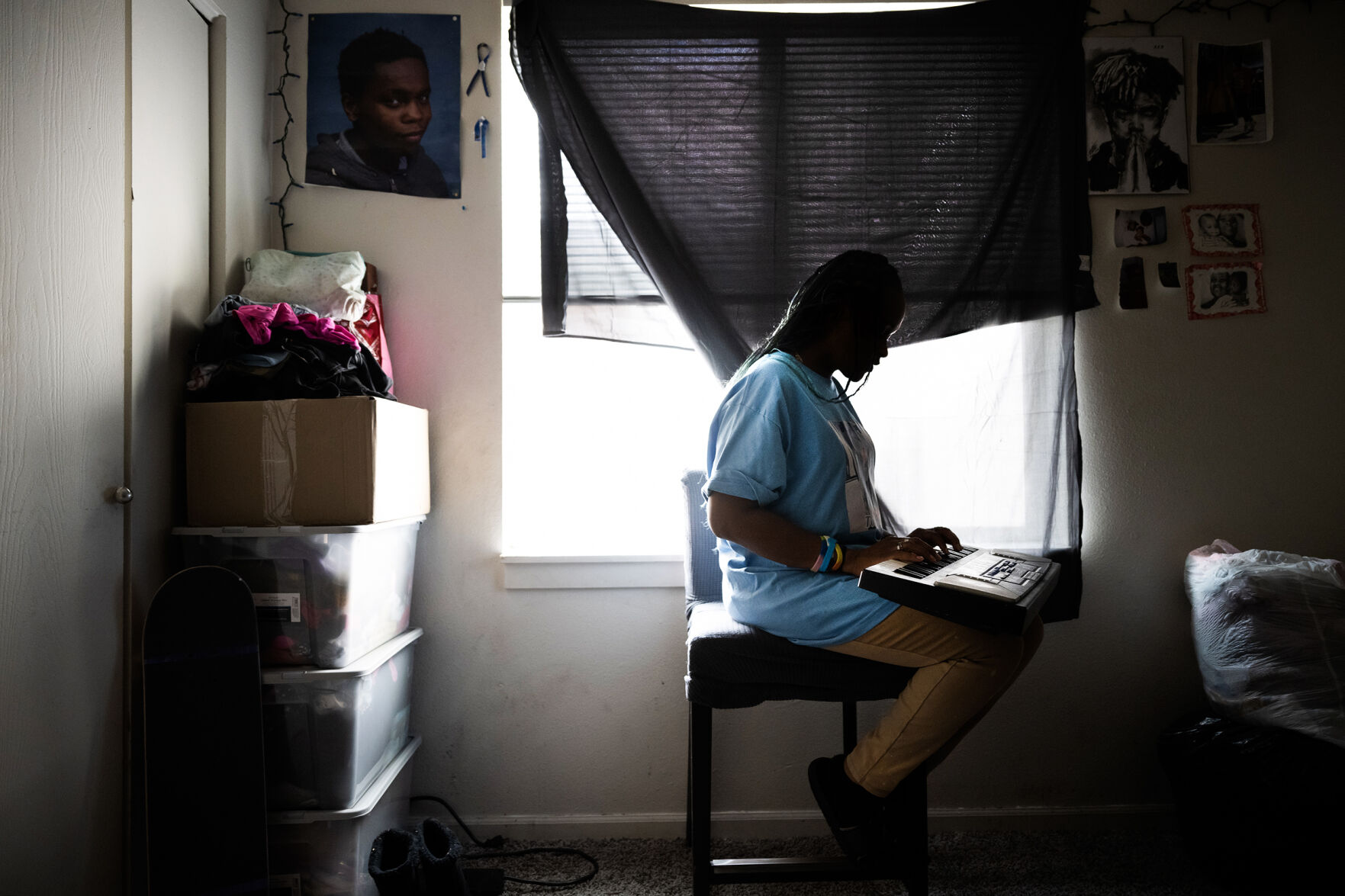 Turquisha Moore Armstrong, the mother and stepmother of Torrence McCall and Elias Armstrong, two brothers who were shot and killed roughly four month apart, reminisces while holding Torrence’s keyboard in his and Elias’ bedroom on Monday, March 20, 2023, at her home in Denver, Colo. (Timothy Hurst/Denver Gazette) (TimHursttim.hurst@gazette.comhttps://secure.gravatar.com/avatar/aca82bd62b4ee425c598527cd6faa1b1?d=mm&r=g)