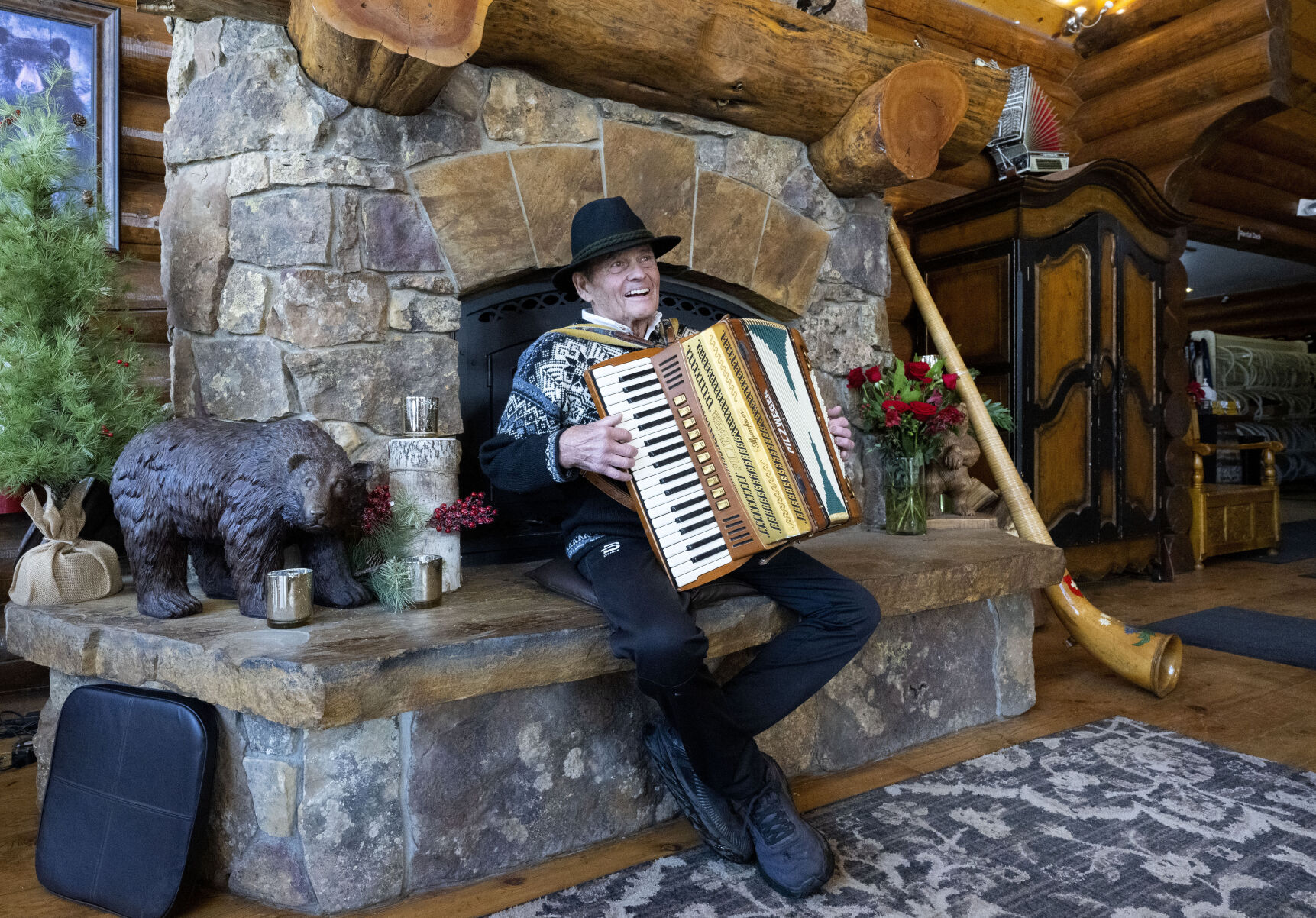 Breckenridge Nordic Center founder and owner Gene Dayton plays the accordion next to the fireplace on Thursday, Nov. 30, 2023, in the Oh, Be Joyful Lodge. The lodge opened Christmas Day of 2013. (Christian Murdock, The Gazette)