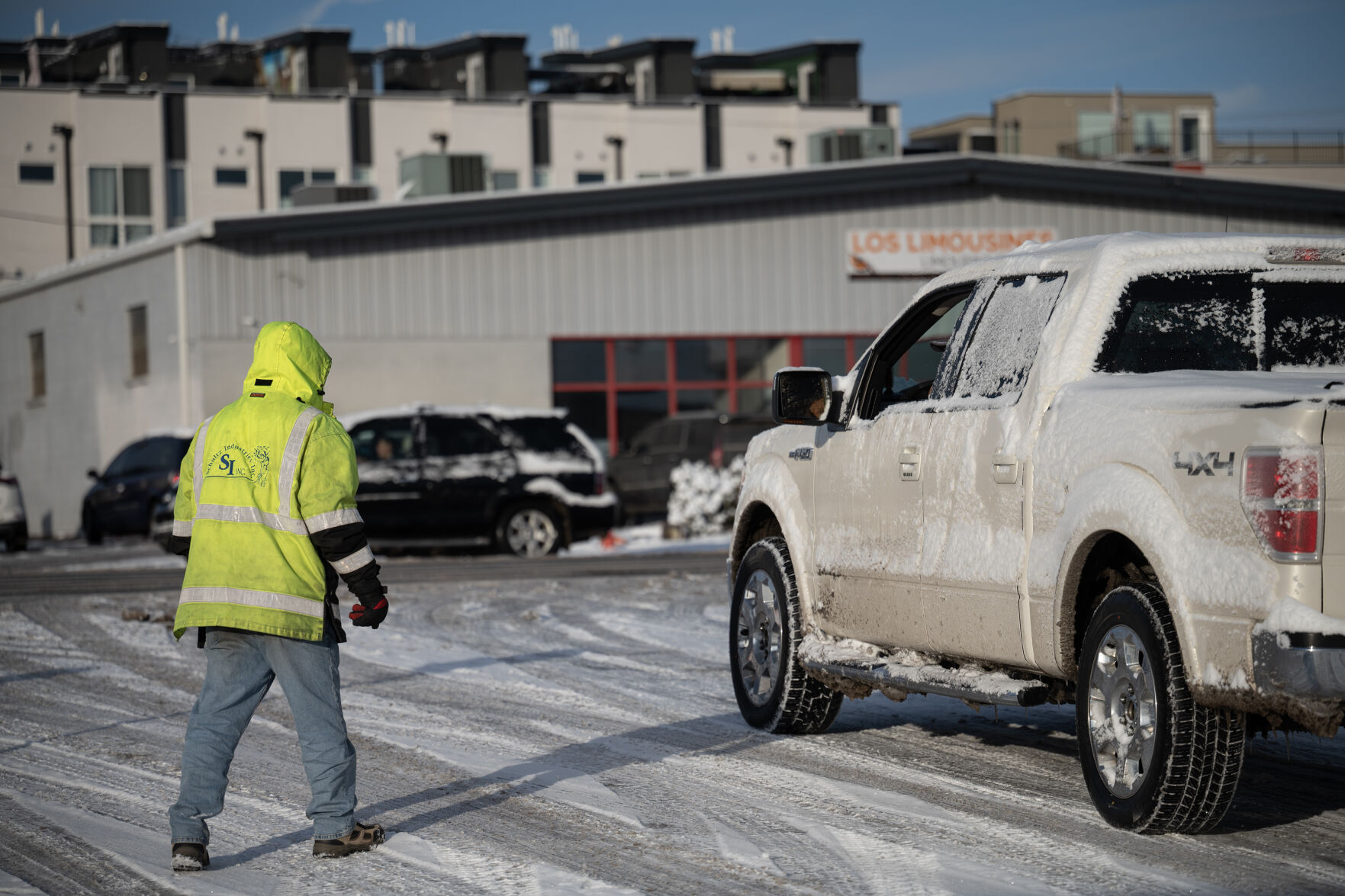 An immigrant worker walks over to a pickup truck to negotiate with the driver while waiting for a potential job for the day at Federal Boulevard and West 19th Avenue in Denver. (TimHursttim.hurst@gazette.comhttps://secure.gravatar.com/avatar/aca82bd62b4ee425c598527cd6faa1b1?d=mm&r=g)