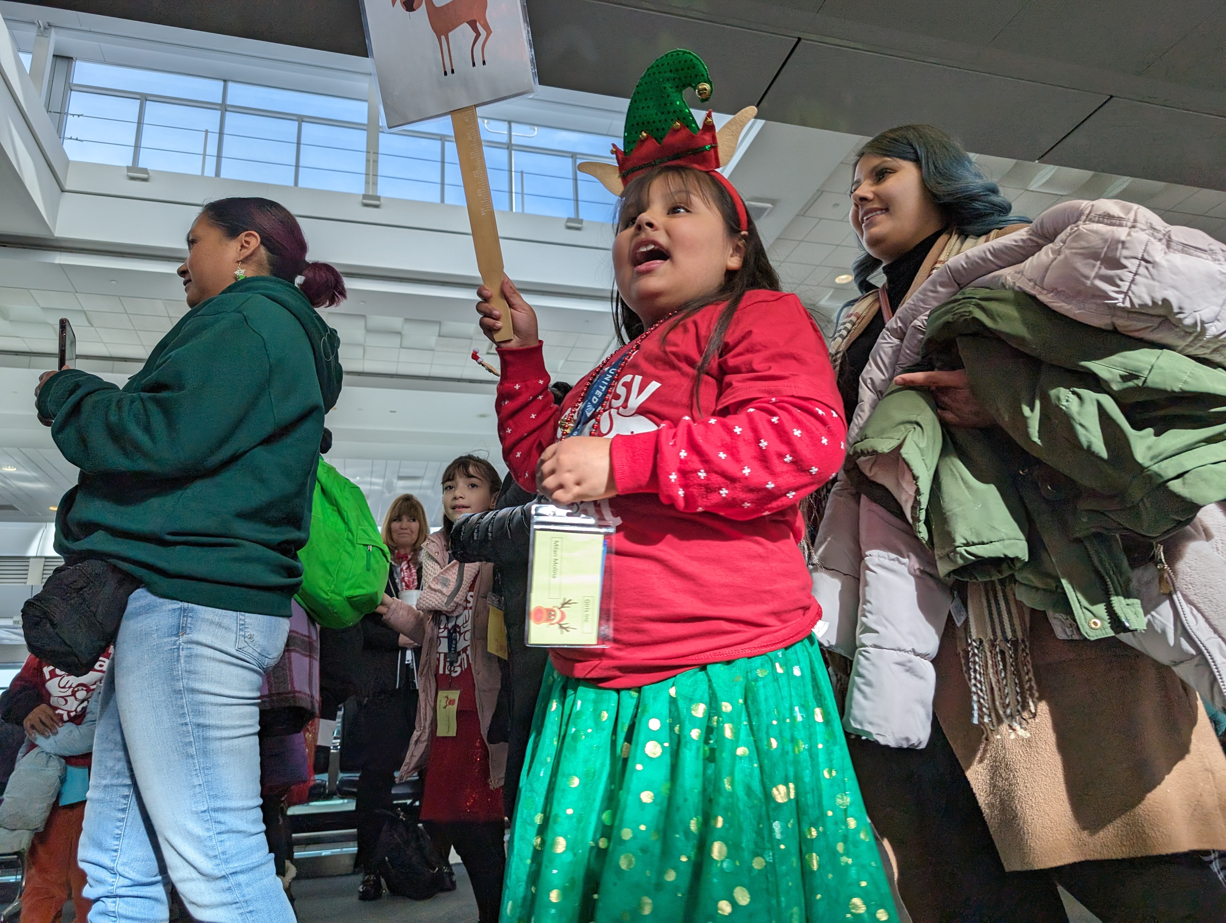 The over-75 children arriving at the United Airlines gate were in absolute shock at the decorated area, holiday music and cheering volunteer decked out in flashy costumes. (SageKelleyJefferson County Reportersage.kelley@denvergazette.comhttps://denvergazette.com/content/tncms/avatars/e/5f/457/e5f45740-2717-11ee-85b2-ab80f2d36252.5b966c1d2ce4987987665d57c237eda4.png)