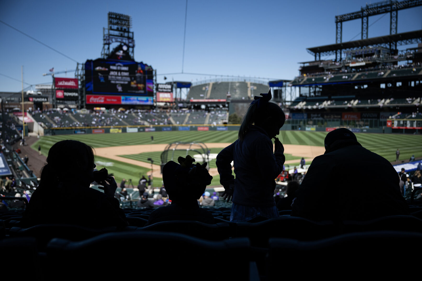 Family members, from left, Lily, 14, Owen, 5, Alexis, 9, and father T.J. Gray enjoy some ballpark snacks at their seats before the Colorado Rockies home opening game against the Washington Nationals on Thursday, April 6, 2023, at Coors Field in Denver, Colo. (Timothy Hurst/Denver Gazette) (TimHursttim.hurst@gazette.comhttps://secure.gravatar.com/avatar/aca82bd62b4ee425c598527cd6faa1b1?d=mm&r=g)