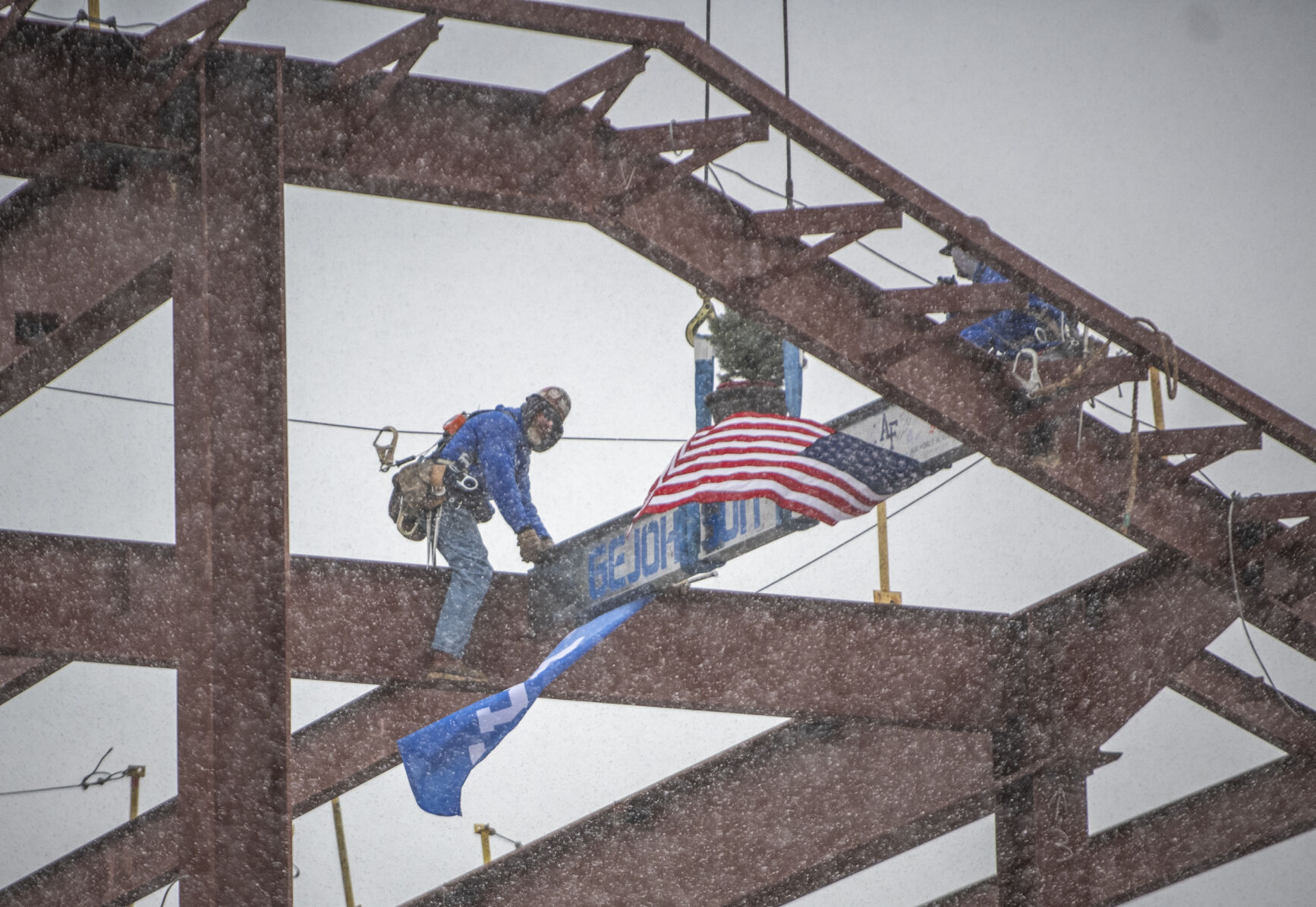 The final beam adorned with signatures and an evergreen tree is placed on the Construction of the East Club at Falcon Stadium at Air Force Academy on Friday, December 8, 2023. (Gabi Broekema)