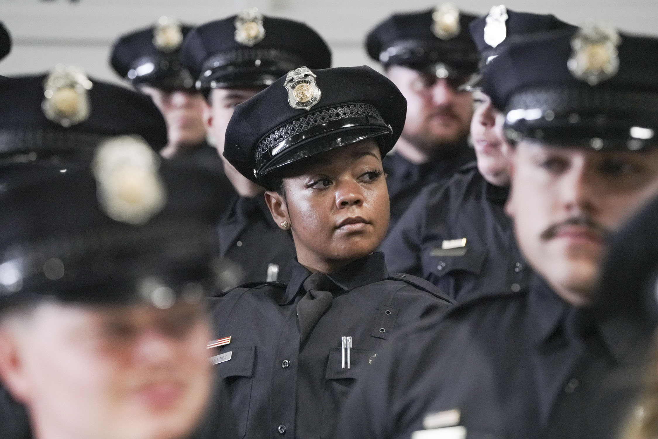 Anyssa Martinez waits for her name to be called to receive her badge during the ceremony at the Denver Police Training Academy on Friday, Dec. 1, 2023 in Denver, Colo. 47 recruit officers were sworn in as Denver Police officers during the ceremony. (Rebecca Slezak/Special to The Denver Gazette) (Rebecca Slezak)