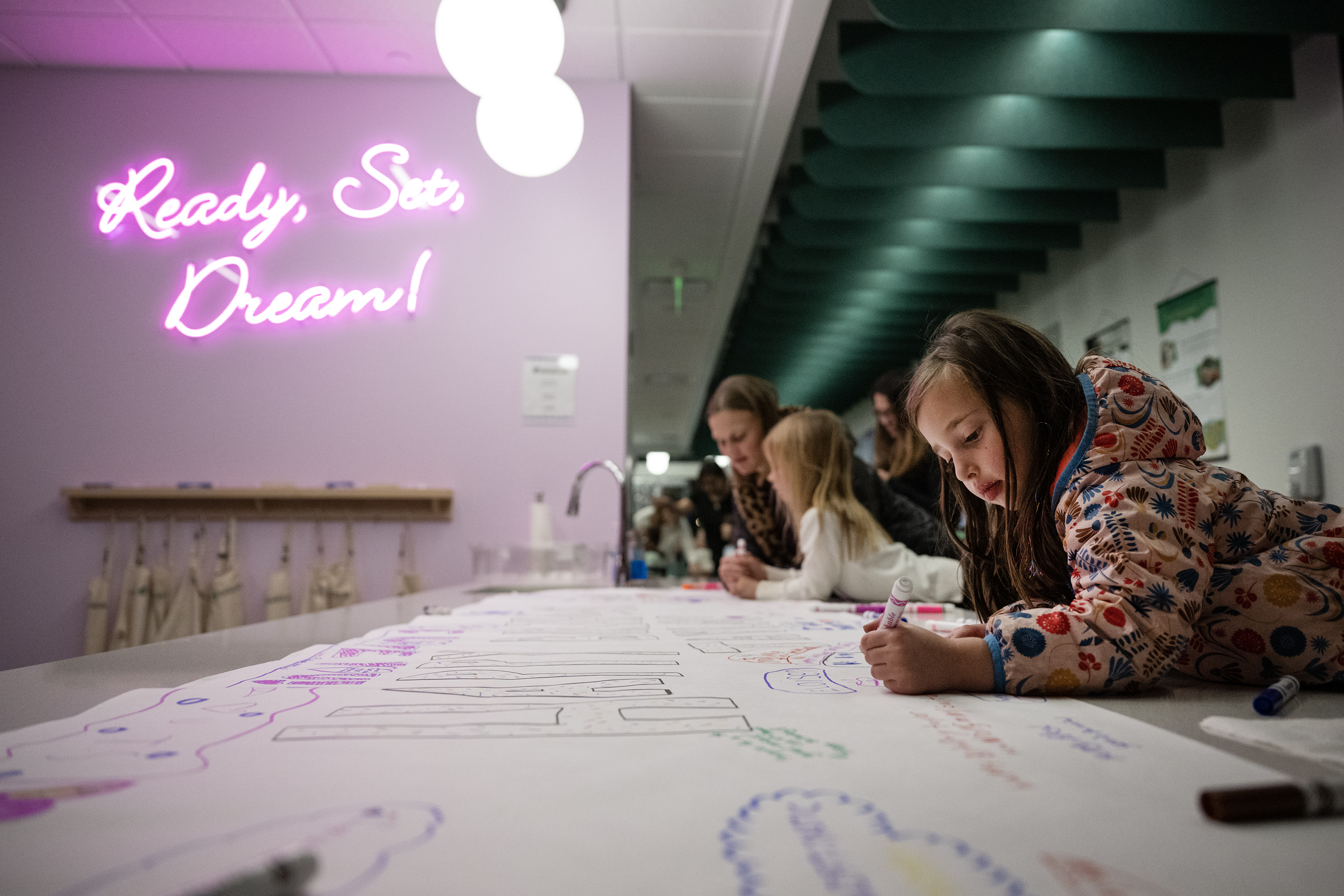 Eloise Schinkai, 5, helps decorate a giant birthday card for musician Taylor Swift’s birthday during the “Mom and Me Swiftie Party!” on Tuesday, Dec. 12, 2023, at the Girl Scouts of Colorado DreamLab in Denver, Colo. (Timothy Hurst/Denver Gazette) (TimHursttim.hurst@gazette.comhttps://secure.gravatar.com/avatar/aca82bd62b4ee425c598527cd6faa1b1?d=mm&r=g)