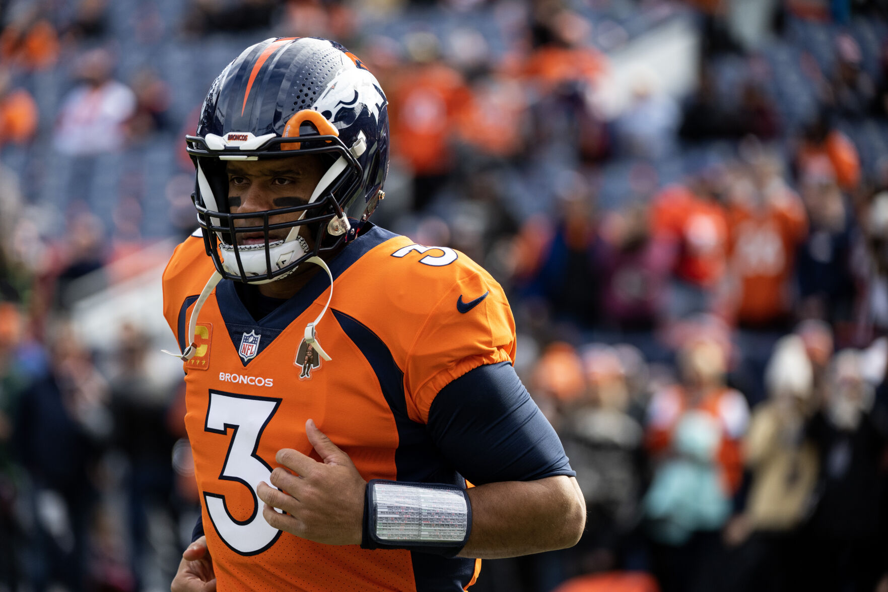 Denver Broncos quarterback Russell Wilson (3) runs onto the field at the start of warmups before a game against the Los Angeles Chargers on Sunday, Nov. 26, 2023, at Empower Field at Mile High in Denver, Colo. (Parker Seibold, The Gazette) (Parker Seibold)