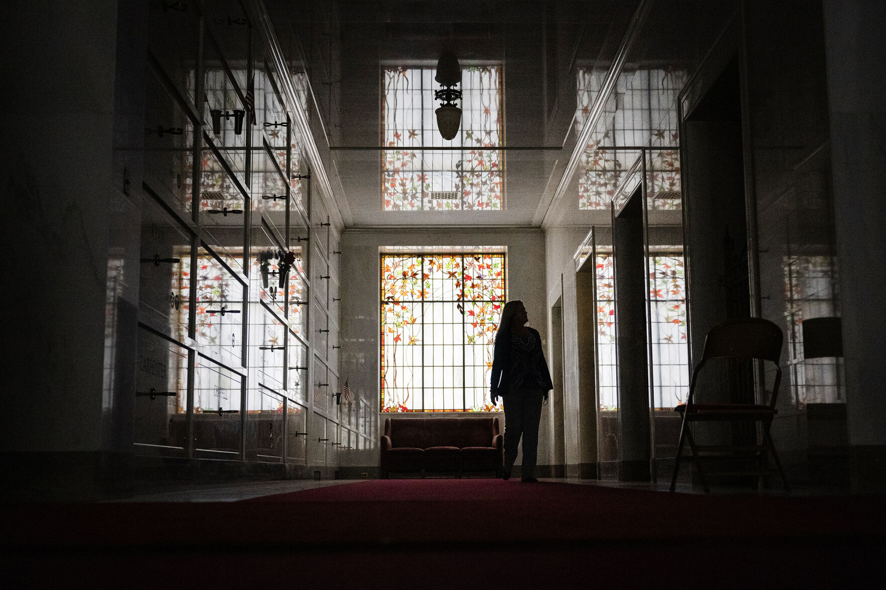Fairmount Funeral Home, Cemetery & Crematory President and CEO Kendra Briggs walks down one of the many halls in the large mausoleum, which houses the state’s largest collection of stained glass windows, on Wednesday, March 29, 2023 at Fairmount Funeral Home, Cemetery & Crematory in Denver, Colo. (Timothy Hurst/Denver Gazette) (TimHursttim.hurst@gazette.comhttps://secure.gravatar.com/avatar/aca82bd62b4ee425c598527cd6faa1b1?d=mm&r=g)