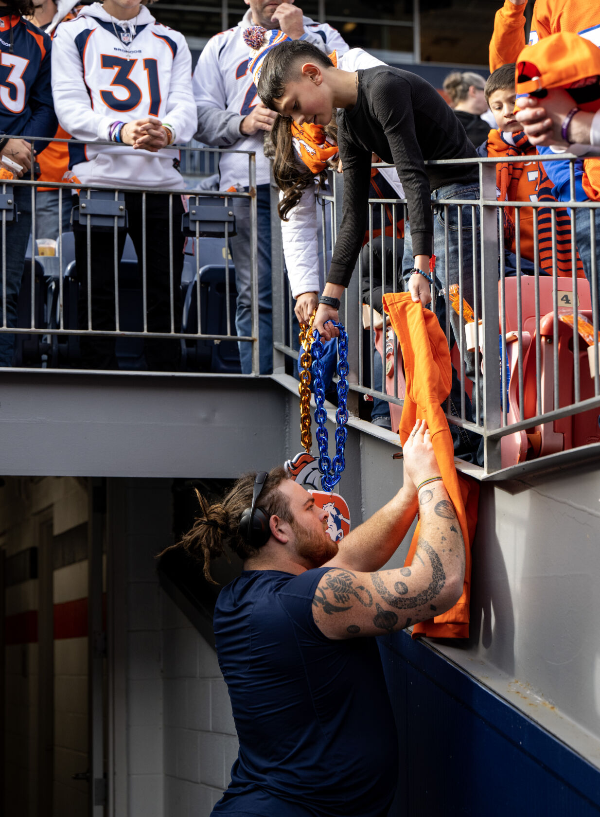 Denver Broncos guard Quinn Meinerz (77) signs a fan’s sweatshirt before a game against the Los Angeles Chargers on Sunday, Nov. 26, 2023, at Empower Field at Mile High in Denver, Colo. (Parker Seibold, The Gazette) (Parker Seibold)
