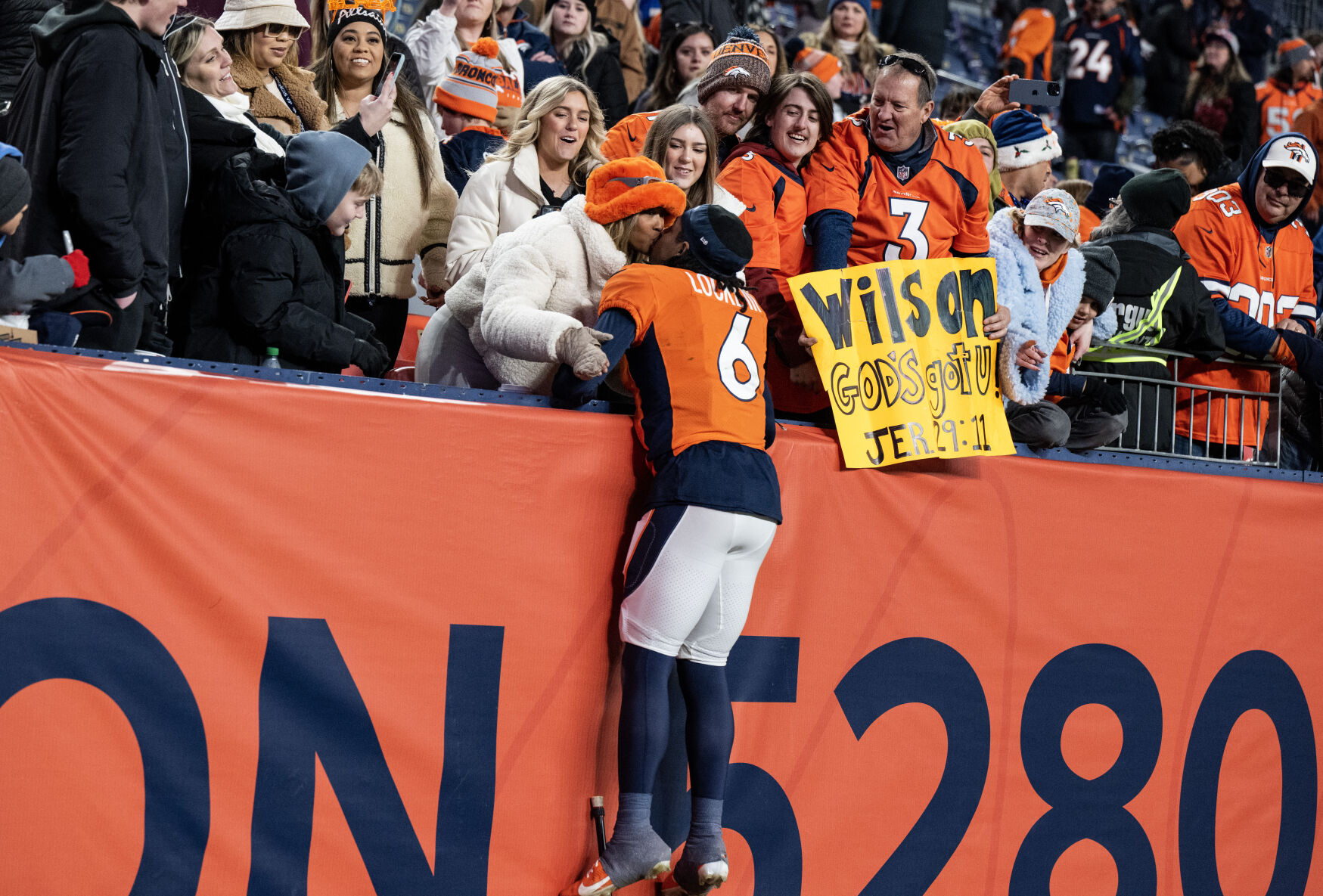 Denver Broncos safety P.J. Locke (6) jumps up to kiss his wife after the Broncos’ win over the Los Angeles Chargers on Sunday, Nov. 26, 2023, at Empower Field at Mile High in Denver, Colo. (Parker Seibold, The Gazette) (Parker Seibold)