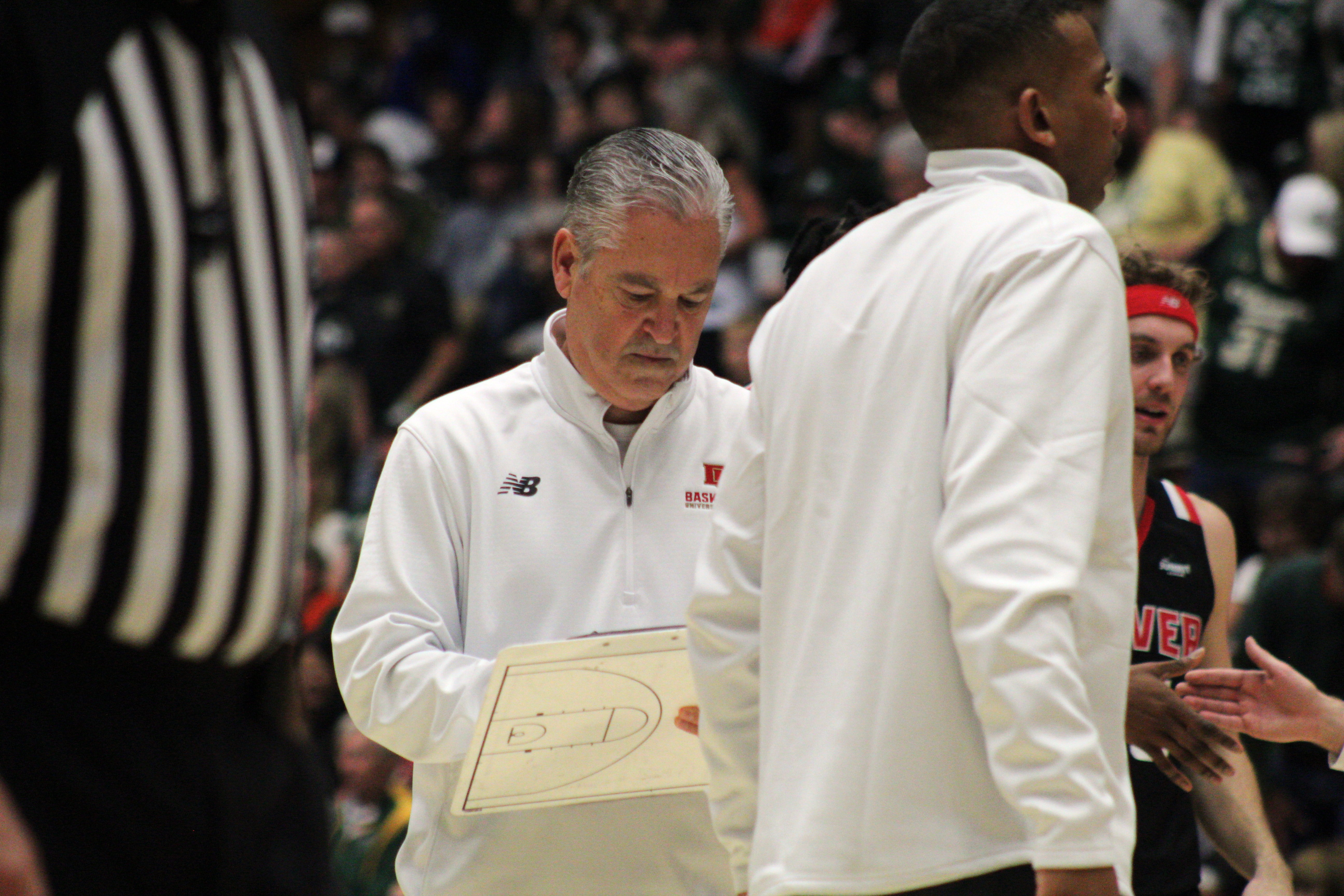 Denver men's basketball coach Jeff Wulbrun prepares to talk with his team during a timeout in a game against Colorado State on Wednesday, Dec. 6, 2023 at Moby Arena in Fort Collins. (Tyler King, The Denver Gazette)