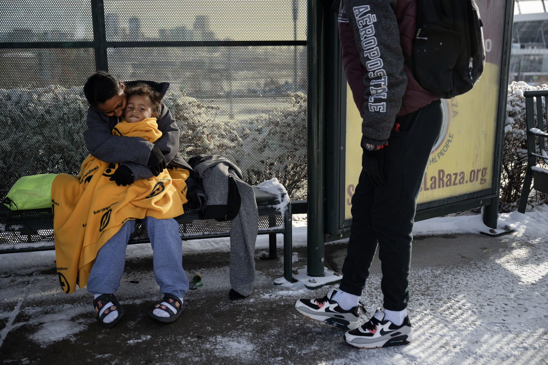 Newly arrived immigrant Ma’riussy Rosa’do nuzzles her 1-year-old son, Jeansdes, after they, her partner and another family of immigrants were dropped off by a bus from El Paso, Texas, at a bus stop near Federal Boulevard and West 19th Avenue after an overnight snowstorm Dec. 9 in Denver. A local contact provided them with jackets, though they were dropped off wearing nothing more than socks and sandals on their feet. (TimHursttim.hurst@gazette.comhttps://secure.gravatar.com/avatar/aca82bd62b4ee425c598527cd6faa1b1?d=mm&r=g)