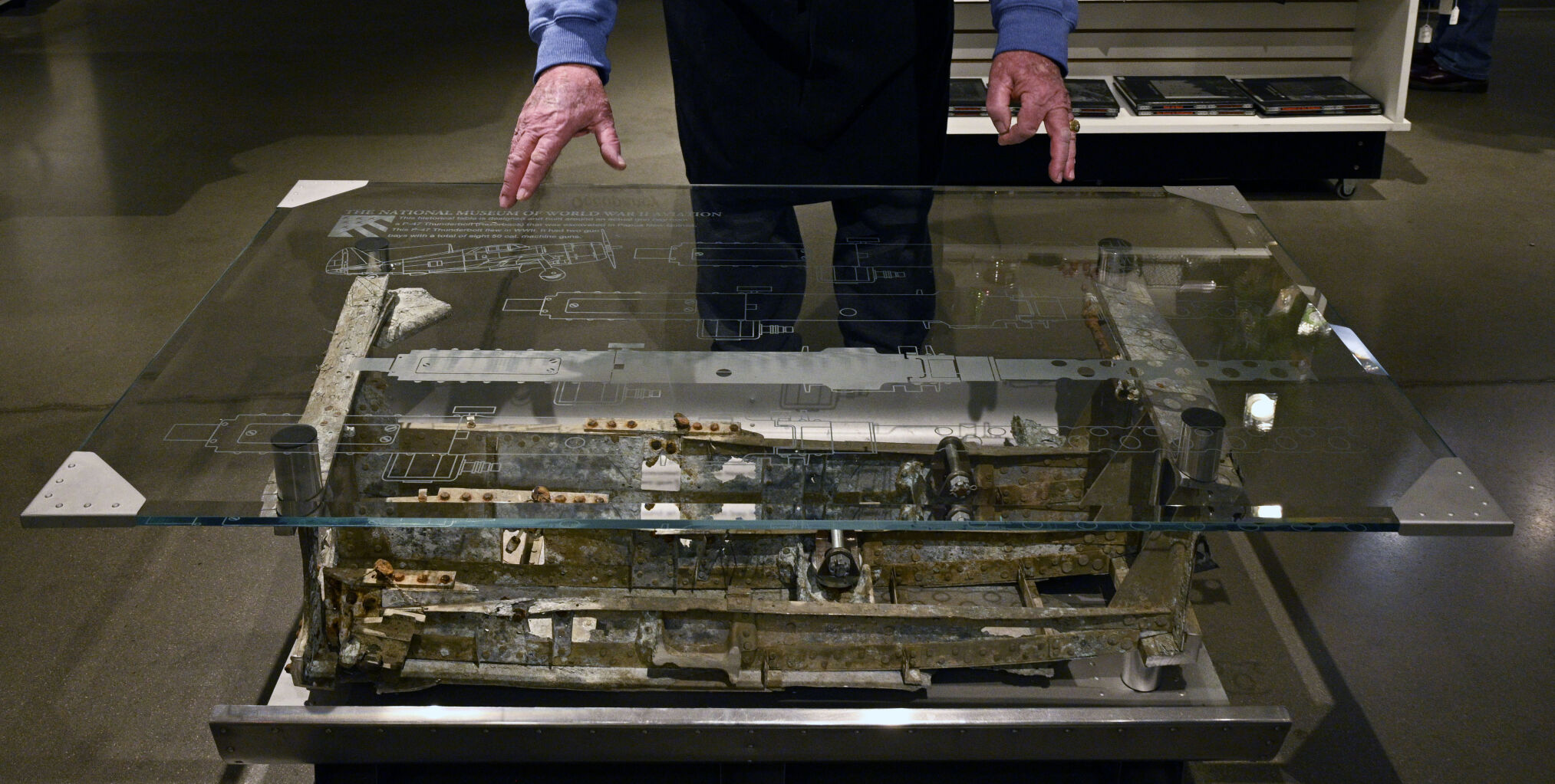 The objets d’art created at the National Museum of World War II Aviation gift shop range in price. At the pricier end is a $15,000 table built around a “rare artifact,” the gun bay of a Republic P-47D Thunderbolt fighter assigned to the “famous 348th Fighter Group” in the southwest Pacific in 1943. (jerilee bennett, the gazette)