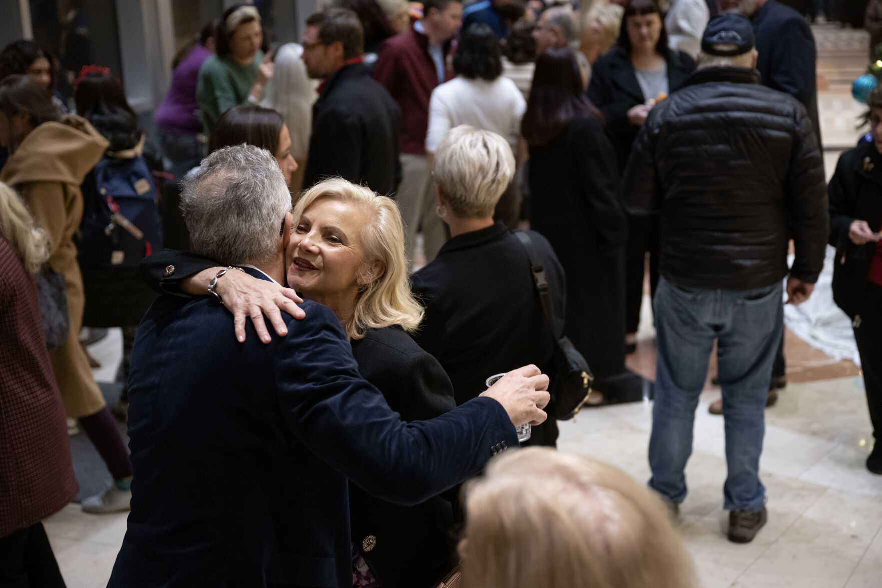 Aurora City Council member Françoise Bergan gets a hug during a reception for new and returning Aurora City Council members on Monday, Dec. 4, 2023, at the Aurora Municipal Center in Aurora, Colo. (Timothy Hurst/Denver Gazette) (TimHursttim.hurst@gazette.comhttps://secure.gravatar.com/avatar/aca82bd62b4ee425c598527cd6faa1b1?d=mm&r=g)