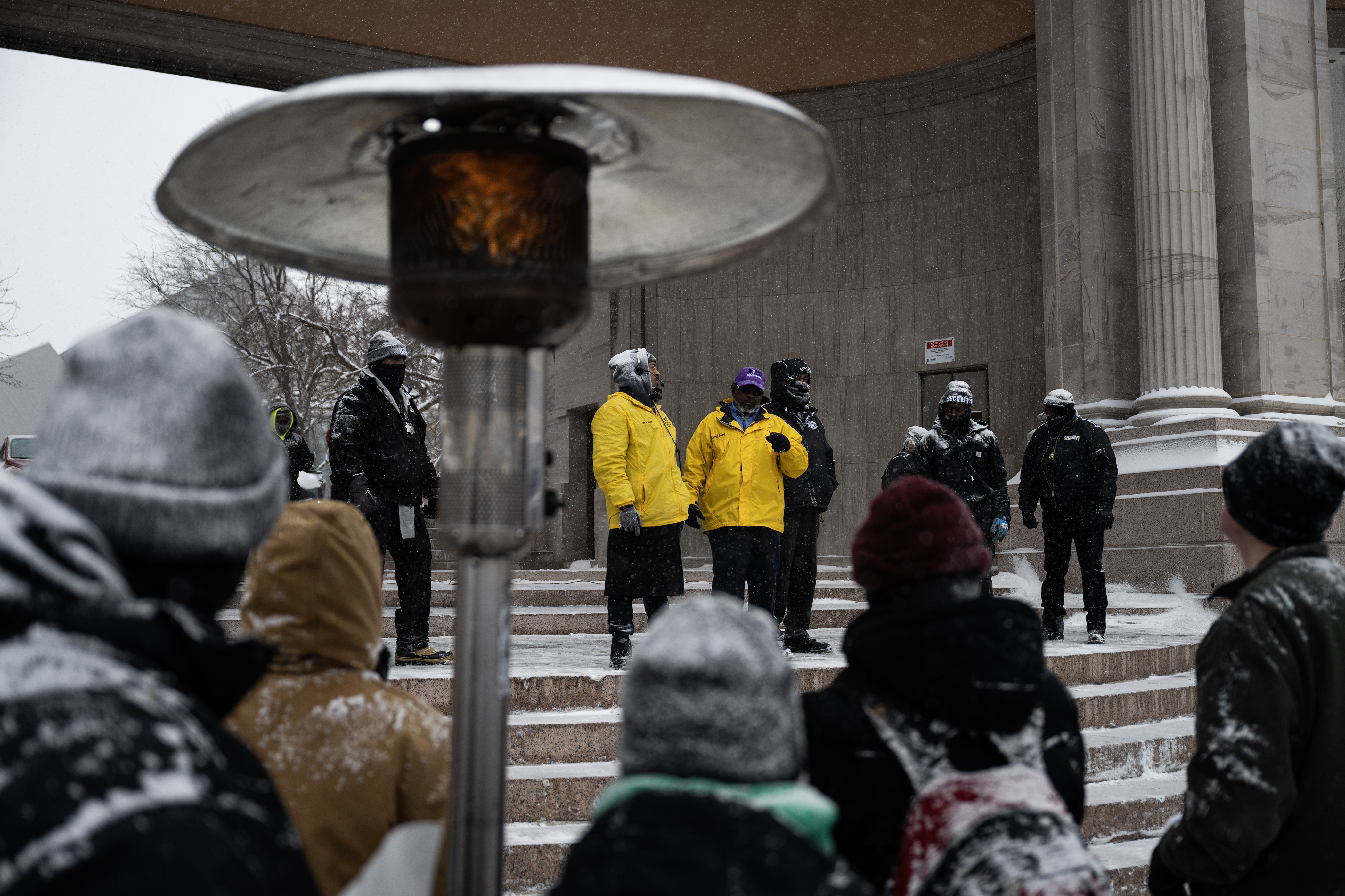 Marade participants huddle under a propane heater as speeches begin after Denver's annual Martin Luther King Jr. Day marade ended at Civic Center Park on Monday, Jan. 15, 2024, in Denver, Colo.(Timothy Hurst/Denver Gazette) (TimHursttim.hurst@gazette.comhttps://secure.gravatar.com/avatar/aca82bd62b4ee425c598527cd6faa1b1?d=mm&r=g)