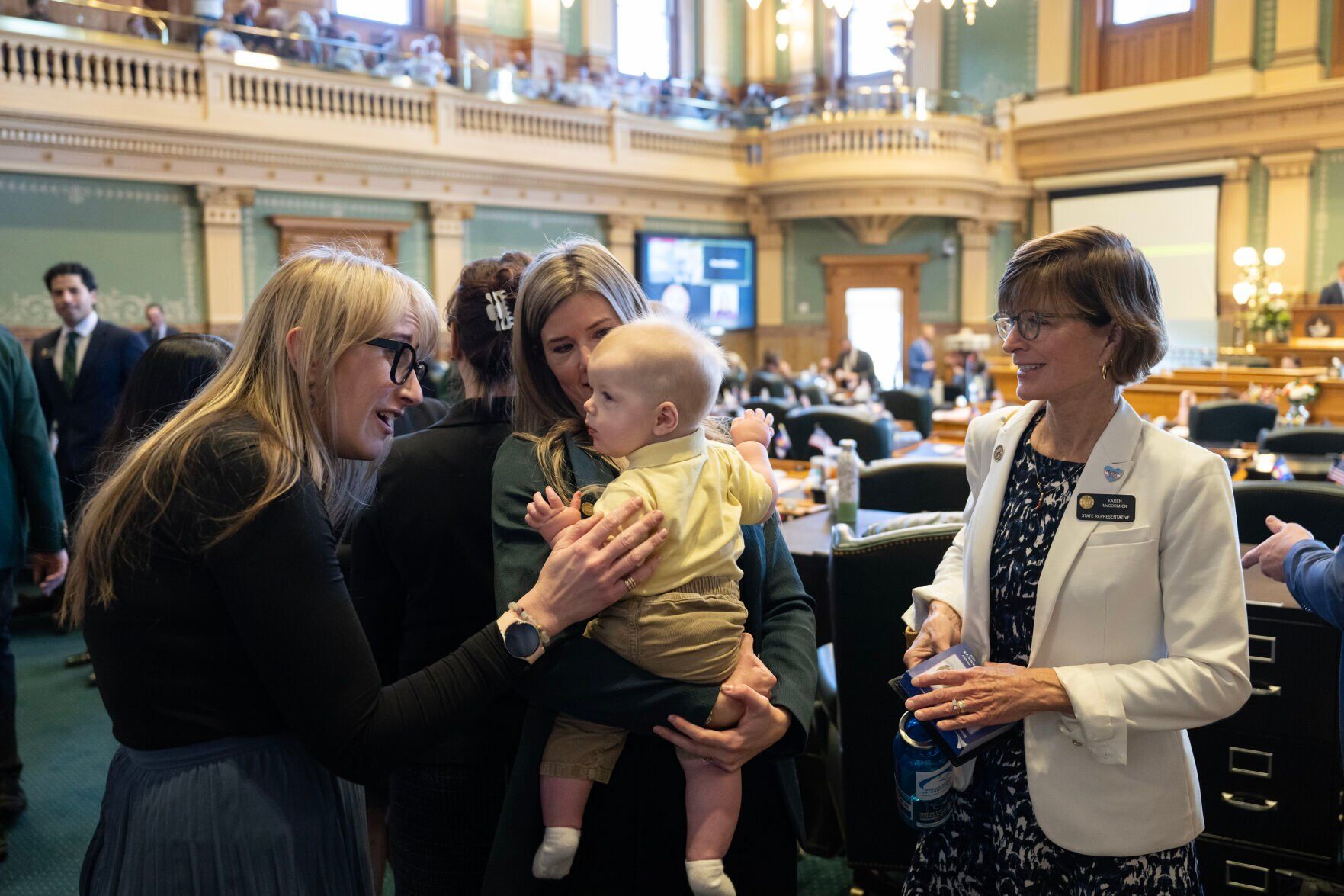 Beka Venturella, left, and Rep. Karen McCormick, right, gather around to meet Rep. Lindsey Daugherty’s seven-month-old son Theodore Ebinger before convening for the first day of Colorado's 2024 legislative session at the Colorado State Capitol building on Wednesday, Jan. 10, 2024, in Denver, Colo.(Timothy Hurst/Denver Gazette) (TimHursttim.hurst@gazette.comhttps://secure.gravatar.com/avatar/aca82bd62b4ee425c598527cd6faa1b1?d=mm&r=g)