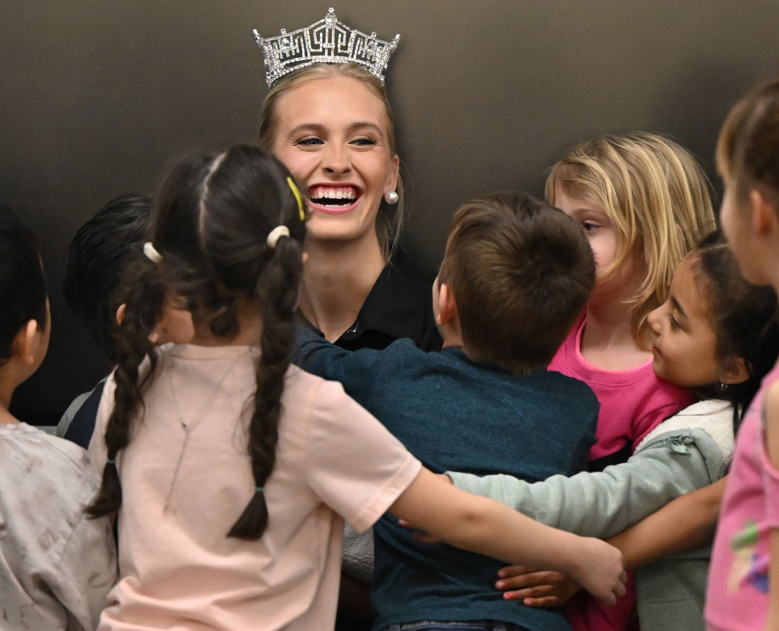 Miss America Madison Marsh gets hugs from first graders at Jackson Elementary School on Wednesday, Jan. 24, 2024. (Photo by Jerilee Bennett, The Gazette)
