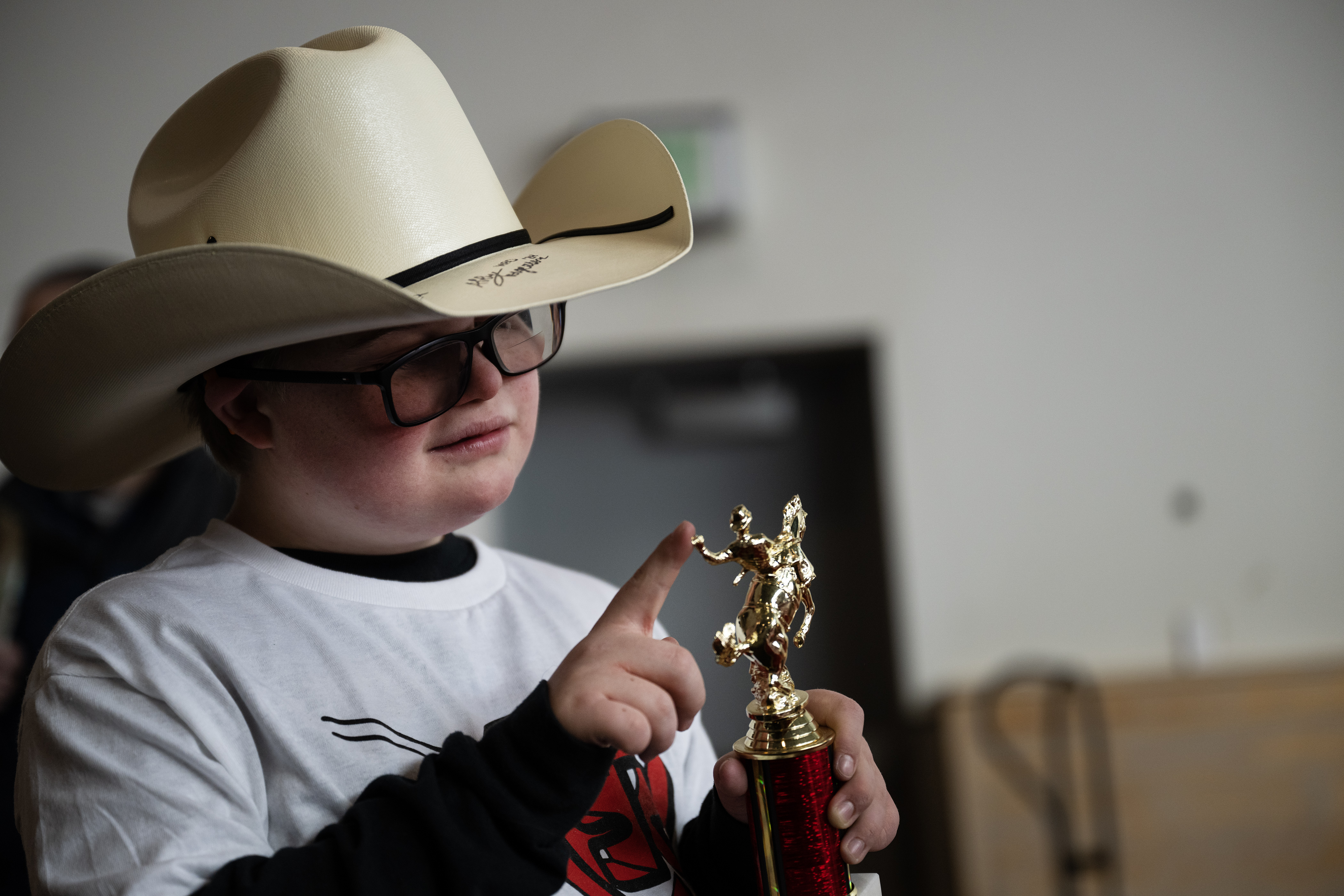 Nico Guadagni closely looks over the trophy he received during the annual PRCA Exceptional Rodeo on Thursday, Jan. 18, 2024, at the Temple Grandin Equine Center at Colorado State University Spur in Denver, Colo.(Timothy Hurst/Denver Gazette) (TimHursttim.hurst@gazette.comhttps://secure.gravatar.com/avatar/aca82bd62b4ee425c598527cd6faa1b1?d=mm&r=g)