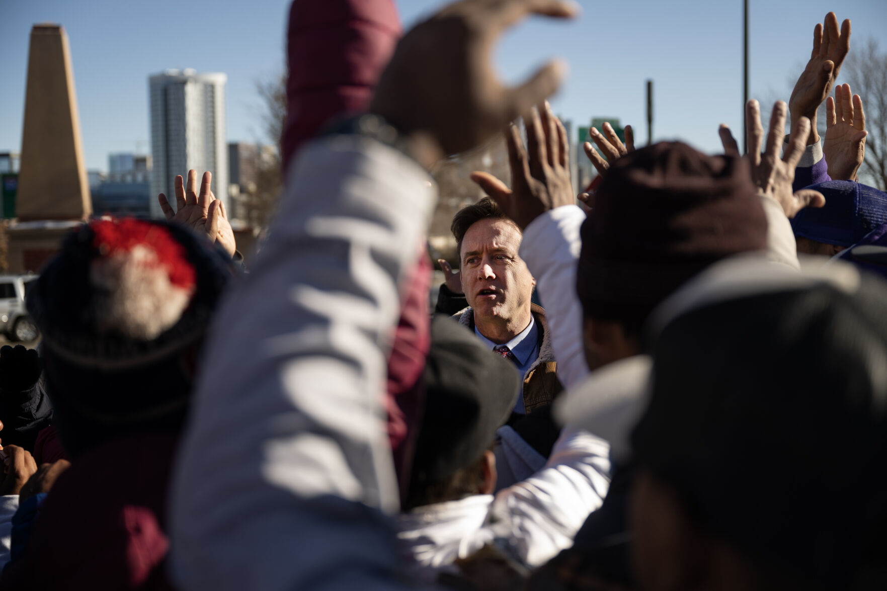 Denver Mayor Mike Johnston asks for a show of hands of everyone in a group gathered around him that is from Venezuela at the encampment at West 27th Avenue and Zuni Street. (TimHursttim.hurst@gazette.comhttps://secure.gravatar.com/avatar/aca82bd62b4ee425c598527cd6faa1b1?d=mm&r=g)