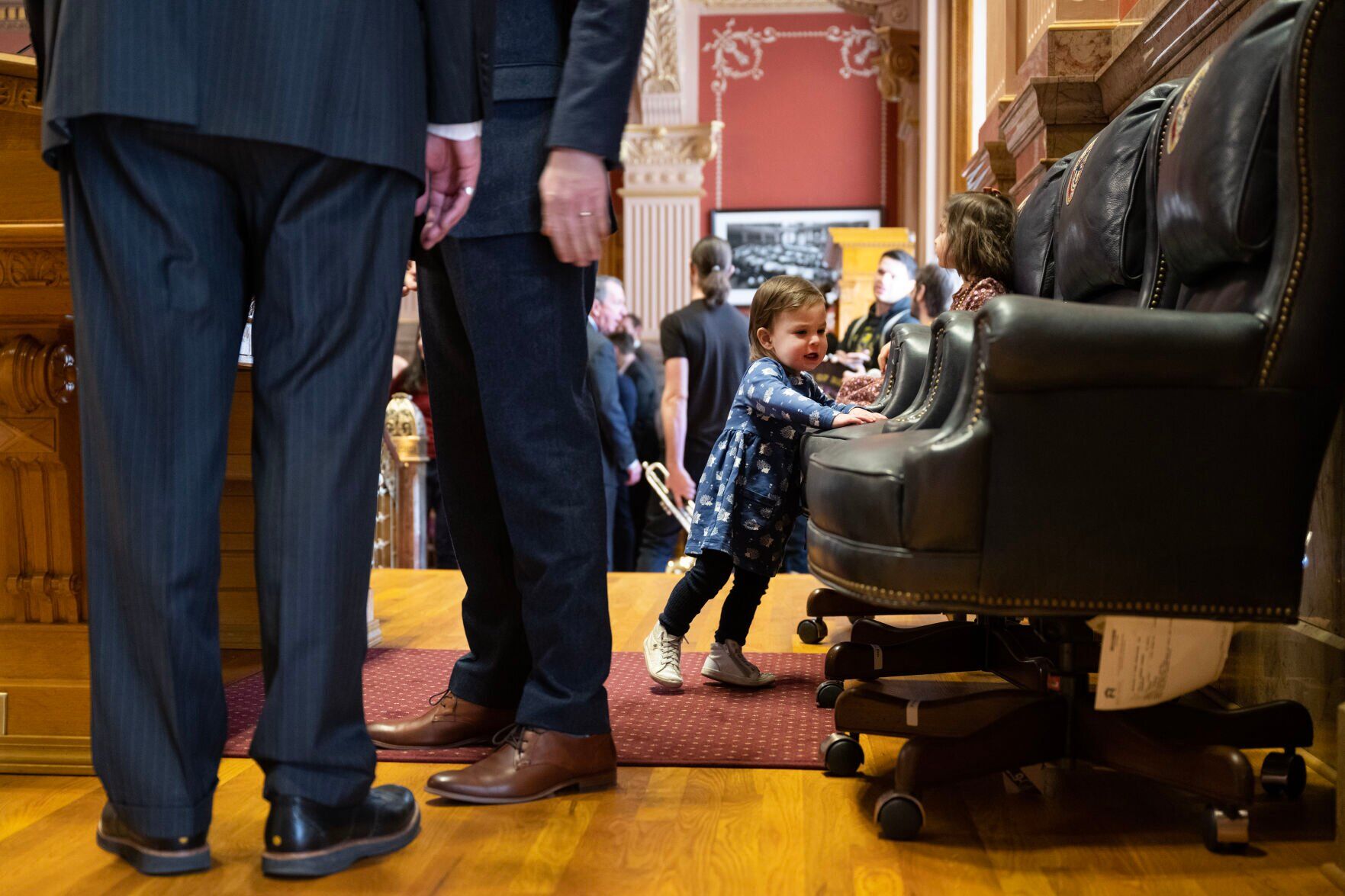 Senate President Steve Fenberg’s daughter Marlow, 1, tries to find her preferred seat behind the gavel while her father talks with another lawmaker before convening the first day of Colorado's 2024 legislative session at the Colorado State Capitol building on Wednesday, Jan. 10, 2024, in Denver, Colo.(Timothy Hurst/Denver Gazette) (TimHursttim.hurst@gazette.comhttps://secure.gravatar.com/avatar/aca82bd62b4ee425c598527cd6faa1b1?d=mm&r=g)