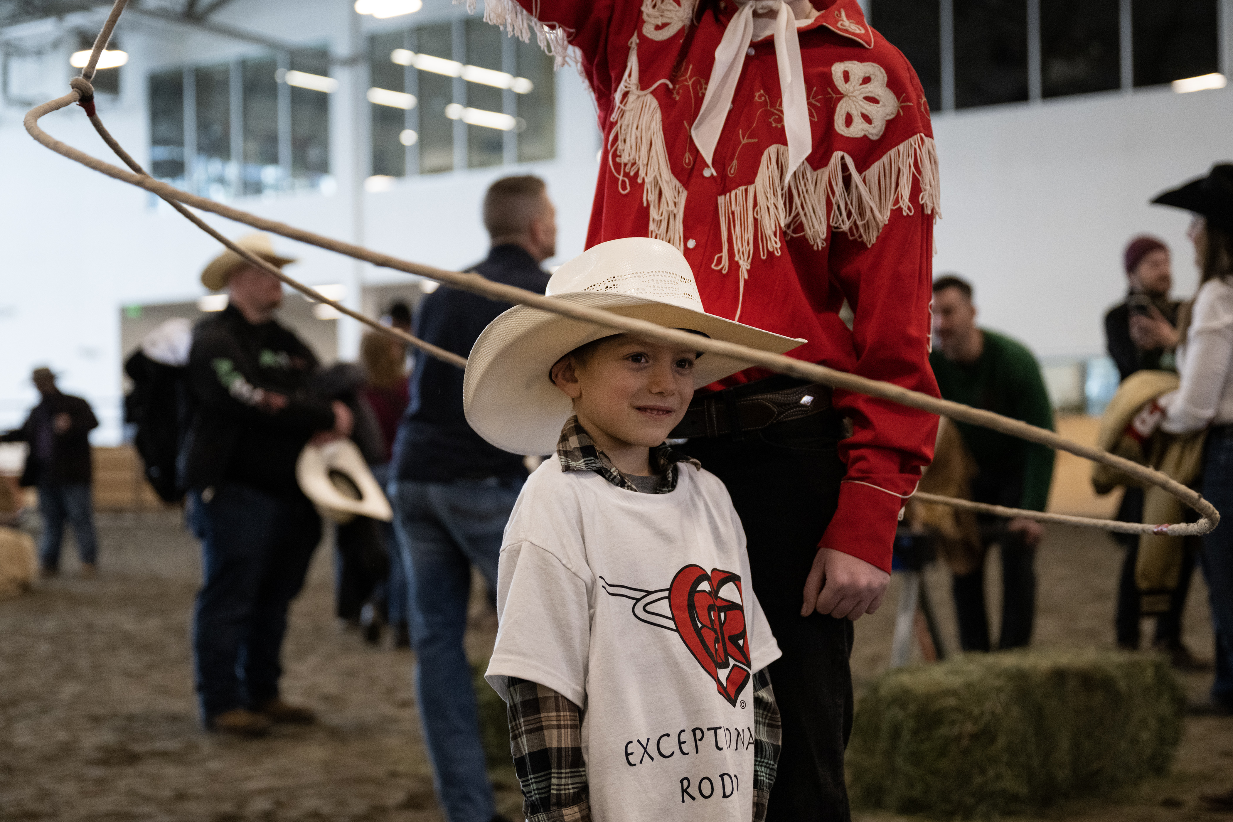 Everett Zentner, 5, stands close to Westernaires trick and fancy roper Mary Clare Cotter as she performs a “wedding ring” rope trick during the annual PRCA Exceptional Rodeo on Thursday, Jan. 18, 2024, at the Temple Grandin Equine Center at Colorado State University Spur in Denver, Colo.(Timothy Hurst/Denver Gazette) (TimHursttim.hurst@gazette.comhttps://secure.gravatar.com/avatar/aca82bd62b4ee425c598527cd6faa1b1?d=mm&r=g)